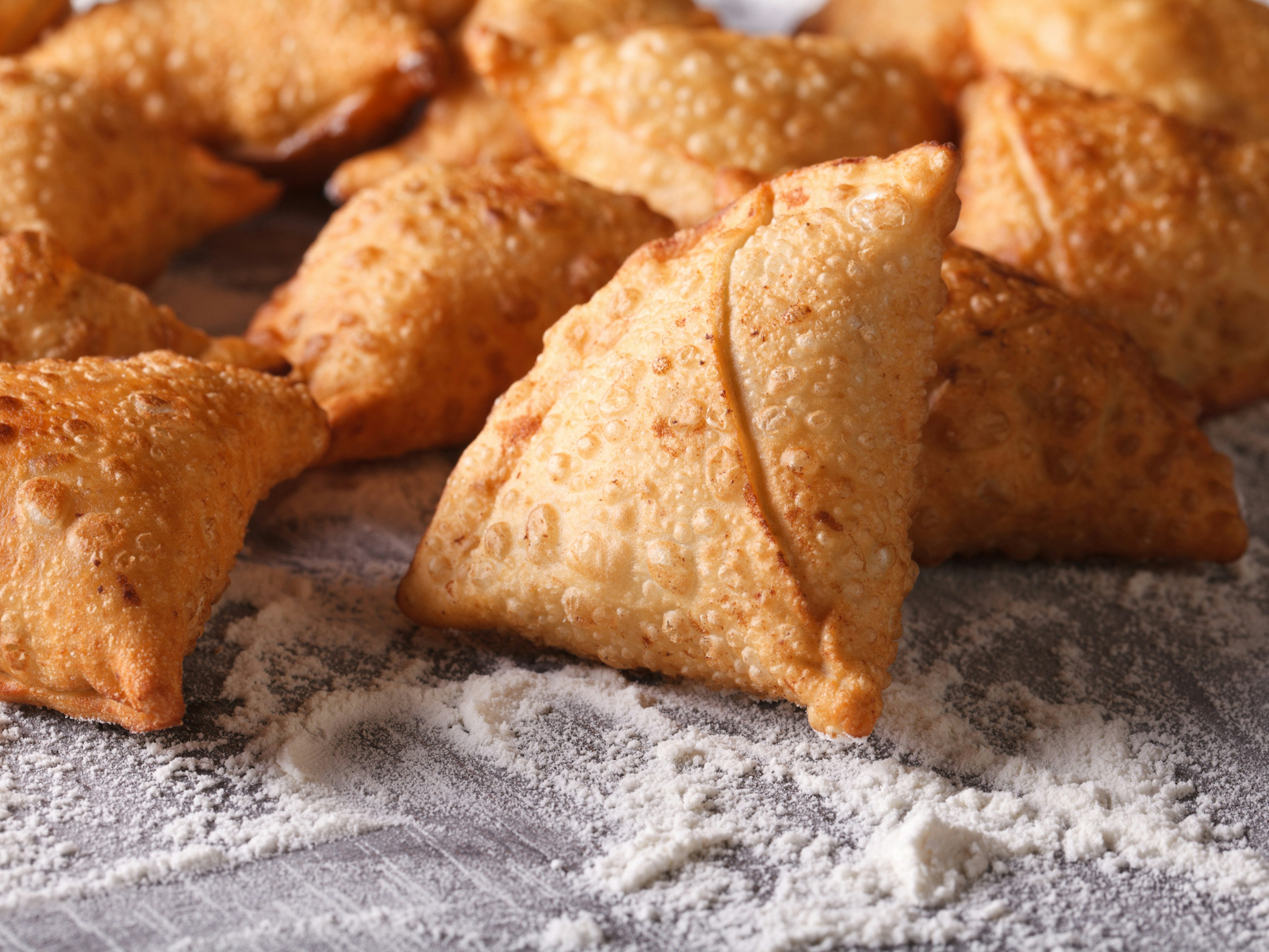 A floured tray of samoosas ? AS Food studio / Shutterstock