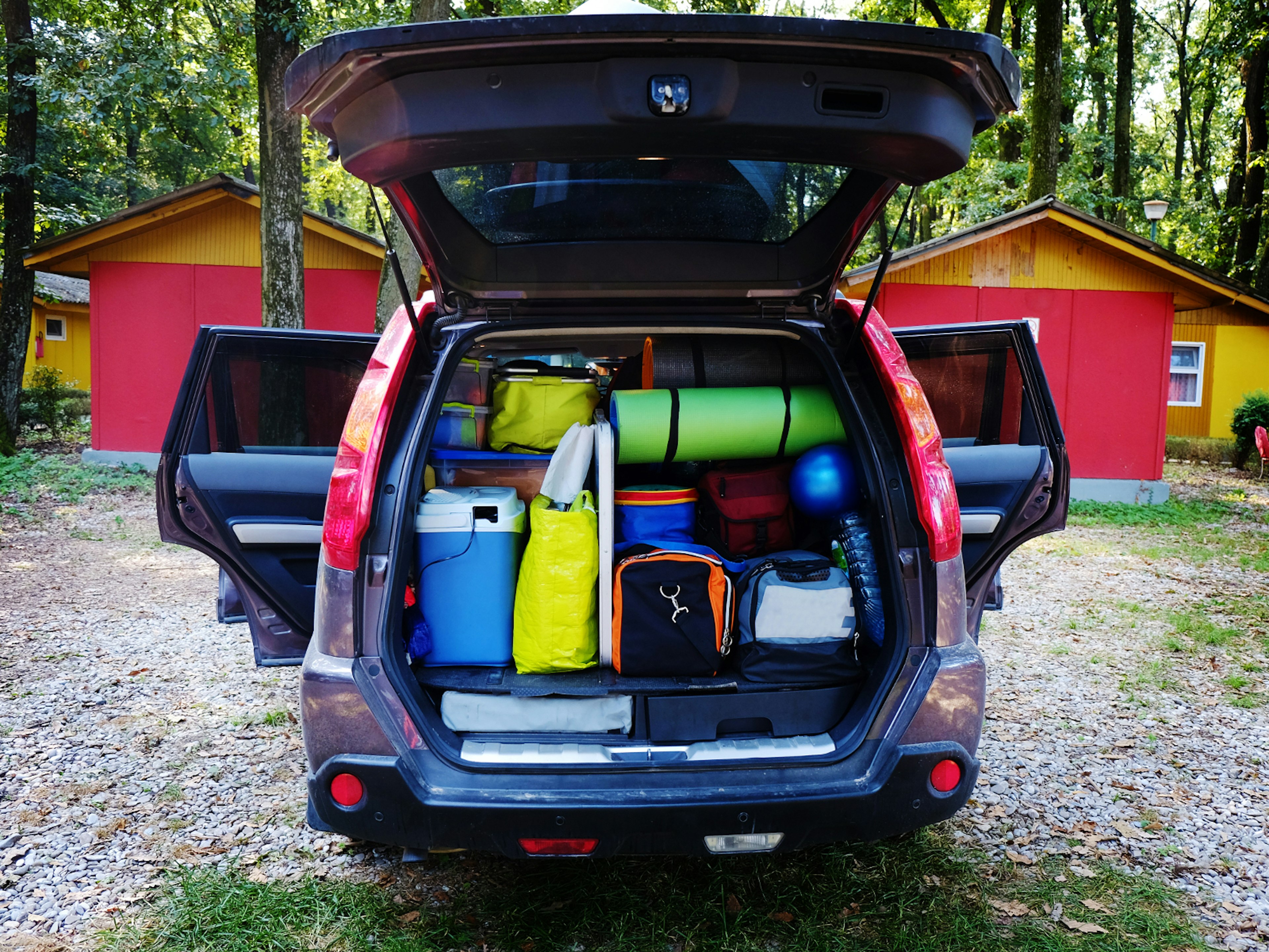 A car boot packed with bags and holiday equipment