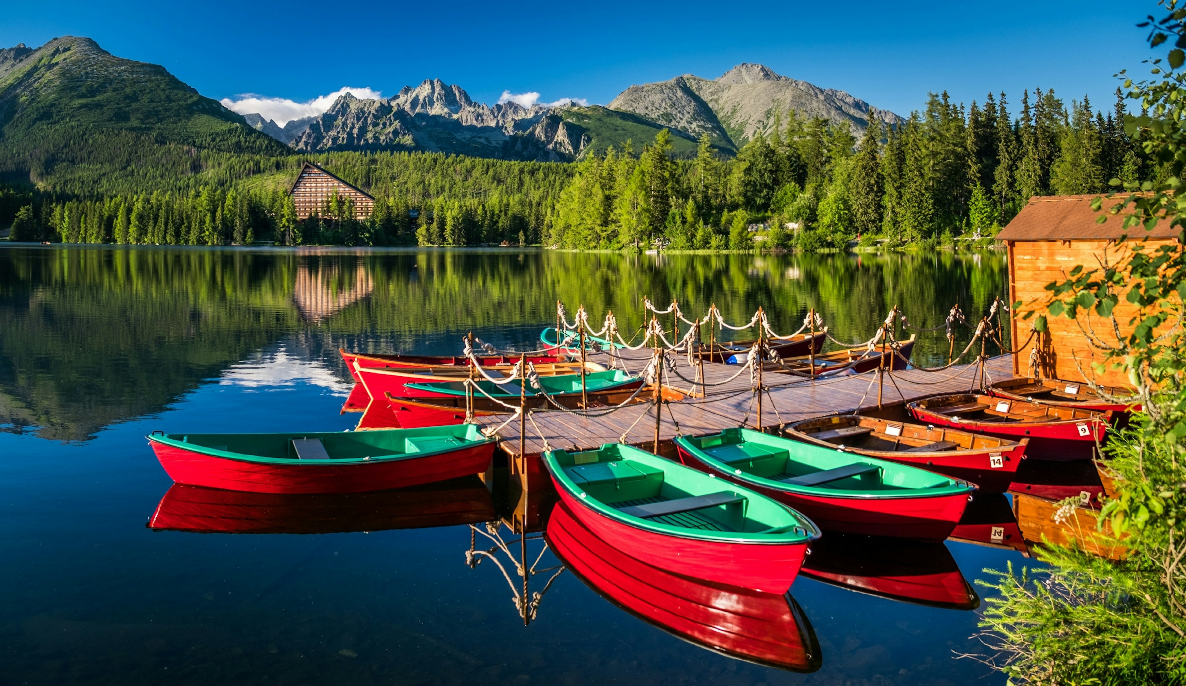 Boats at a pier in the Štrbské Pleso lake.