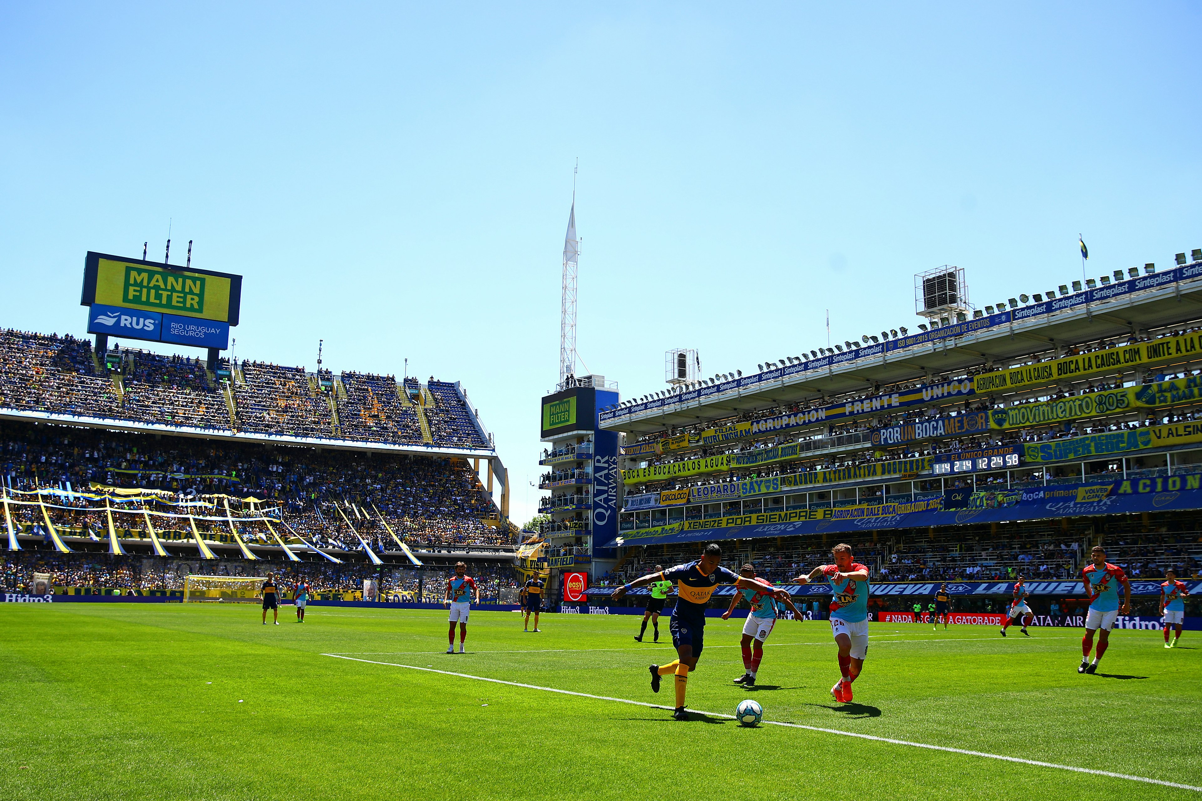 Sporting fans watch two football teams compete at La Bombonera in Buenos Aires