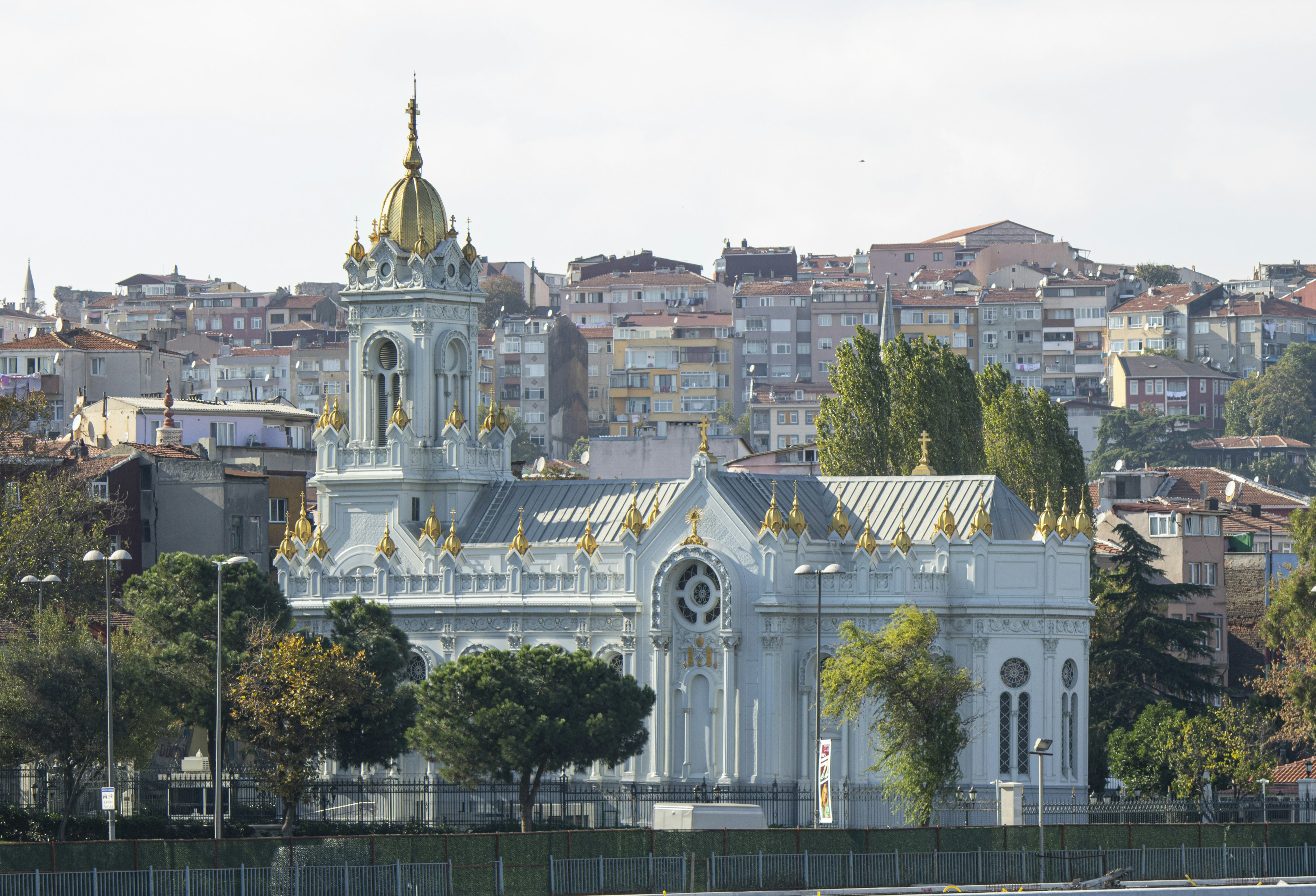 Exterior view of the white Church of St. Stephen of the Bulgars. There is a golden dome with smaller golden domes dotted along the roof