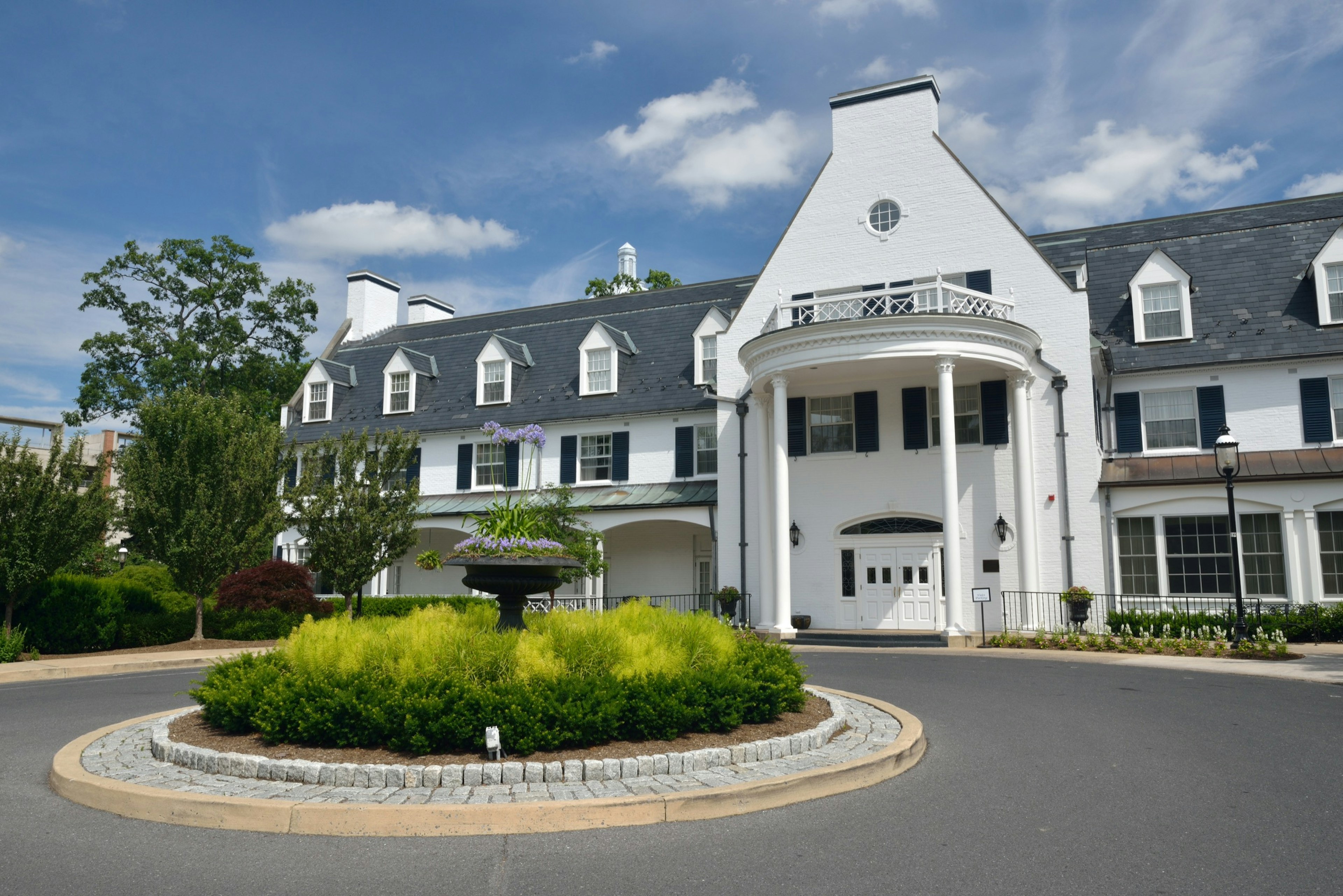 A historic white inn is seen against a brilliant blue sky; Autumn in State College Pennsylvania