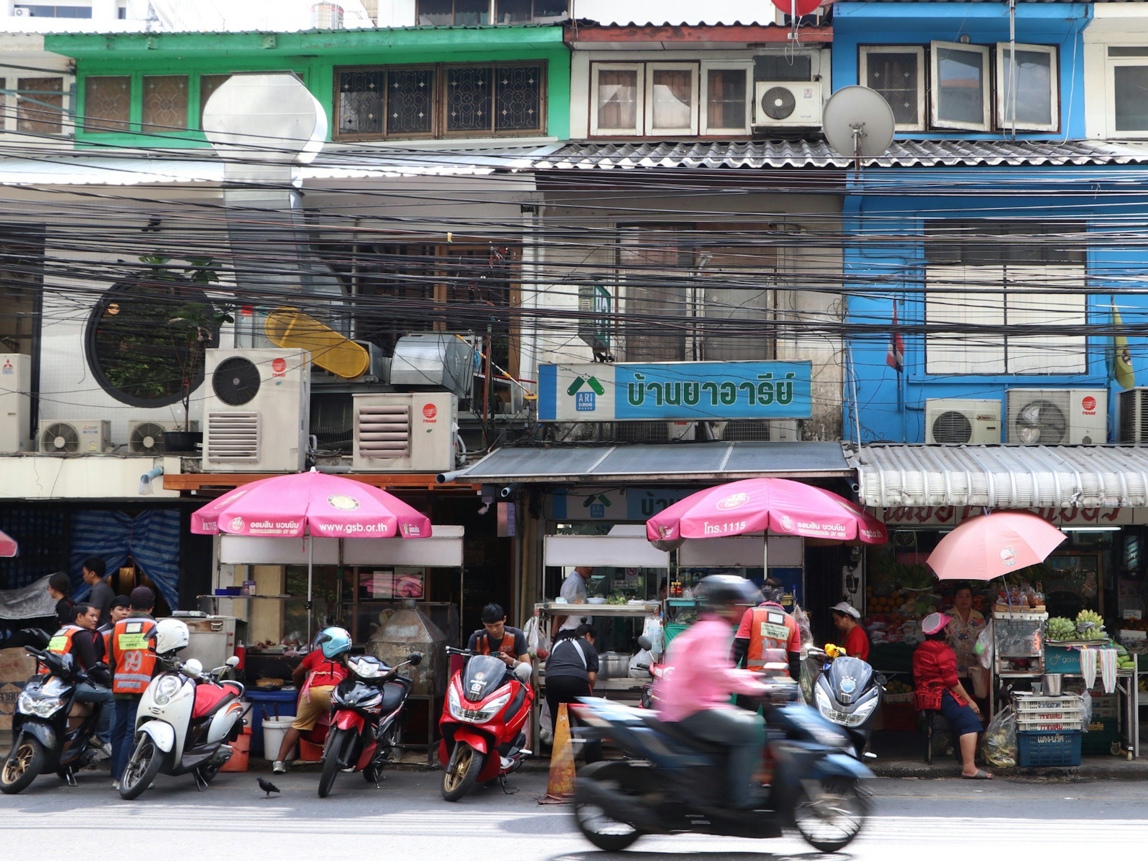 Phahon Yothin 7 in Ari district, lined with street food stalls, seamstresses and cobblers