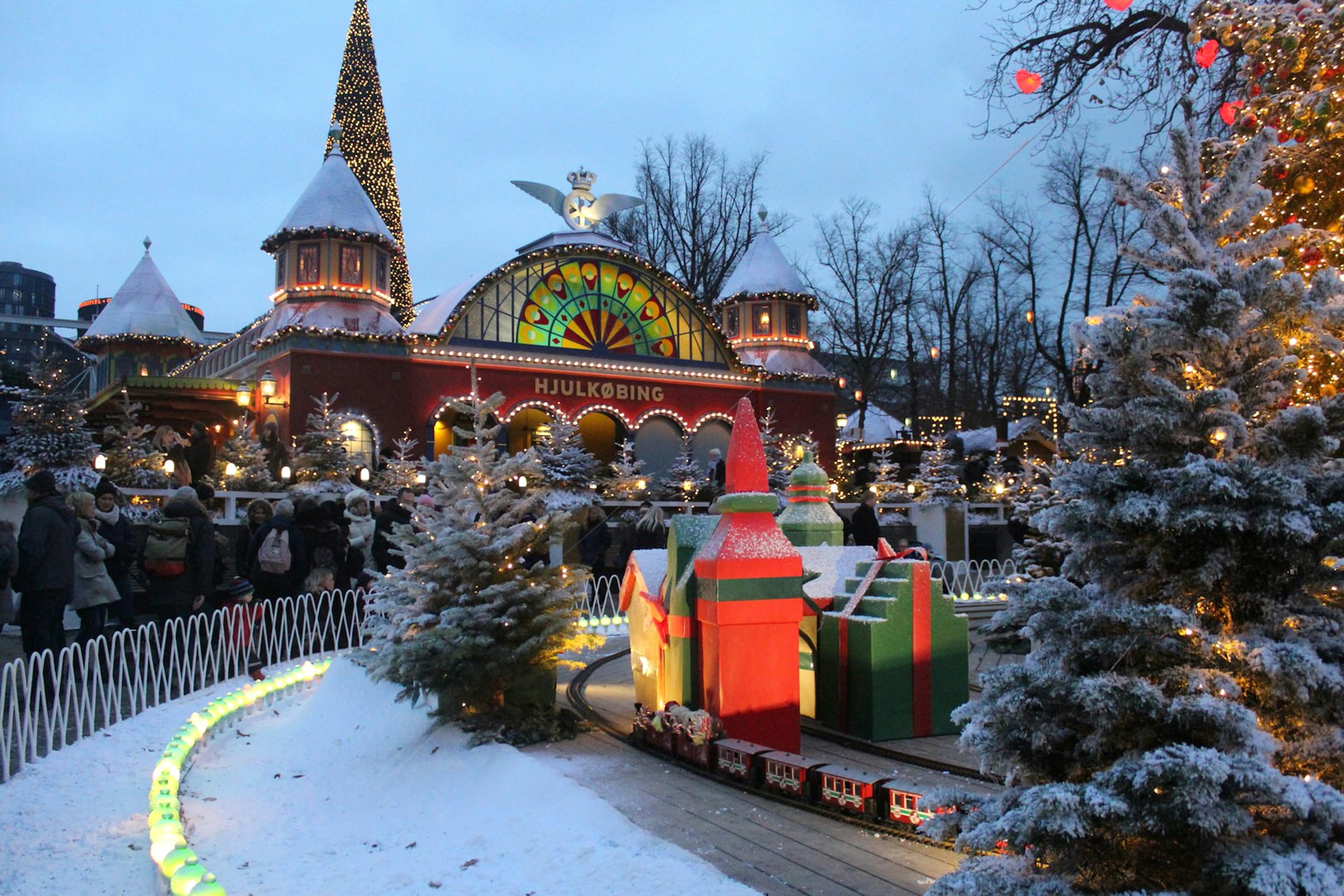 An outdoor shot of Copenhagen's famous Tivoli Gardens, dusted with snow during the Christmas season © Caroline Hadamitzky / Lonely Planet