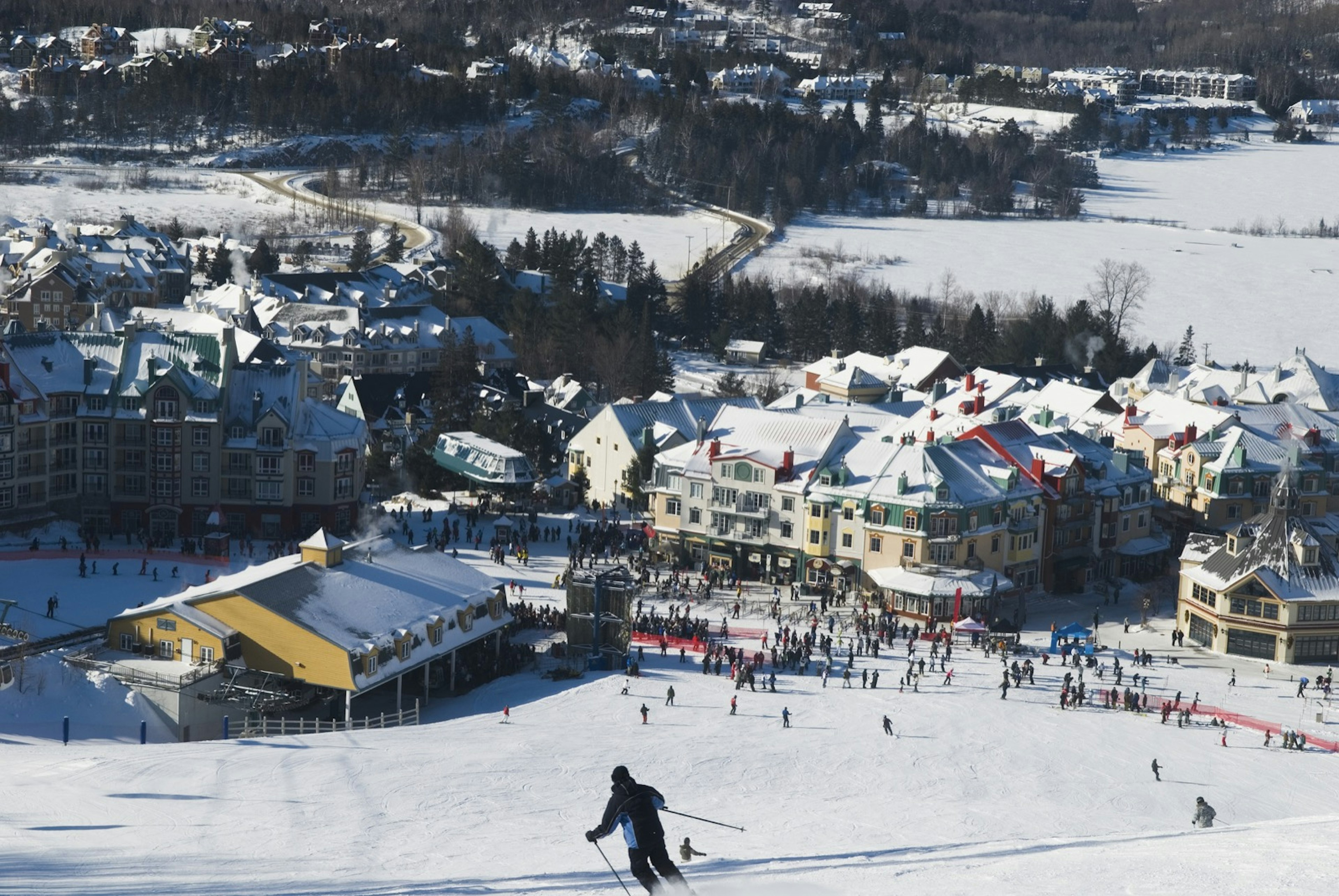 A skier glides down one of the ski trails at a ski resort in the mountains. Best day trips from Montréal