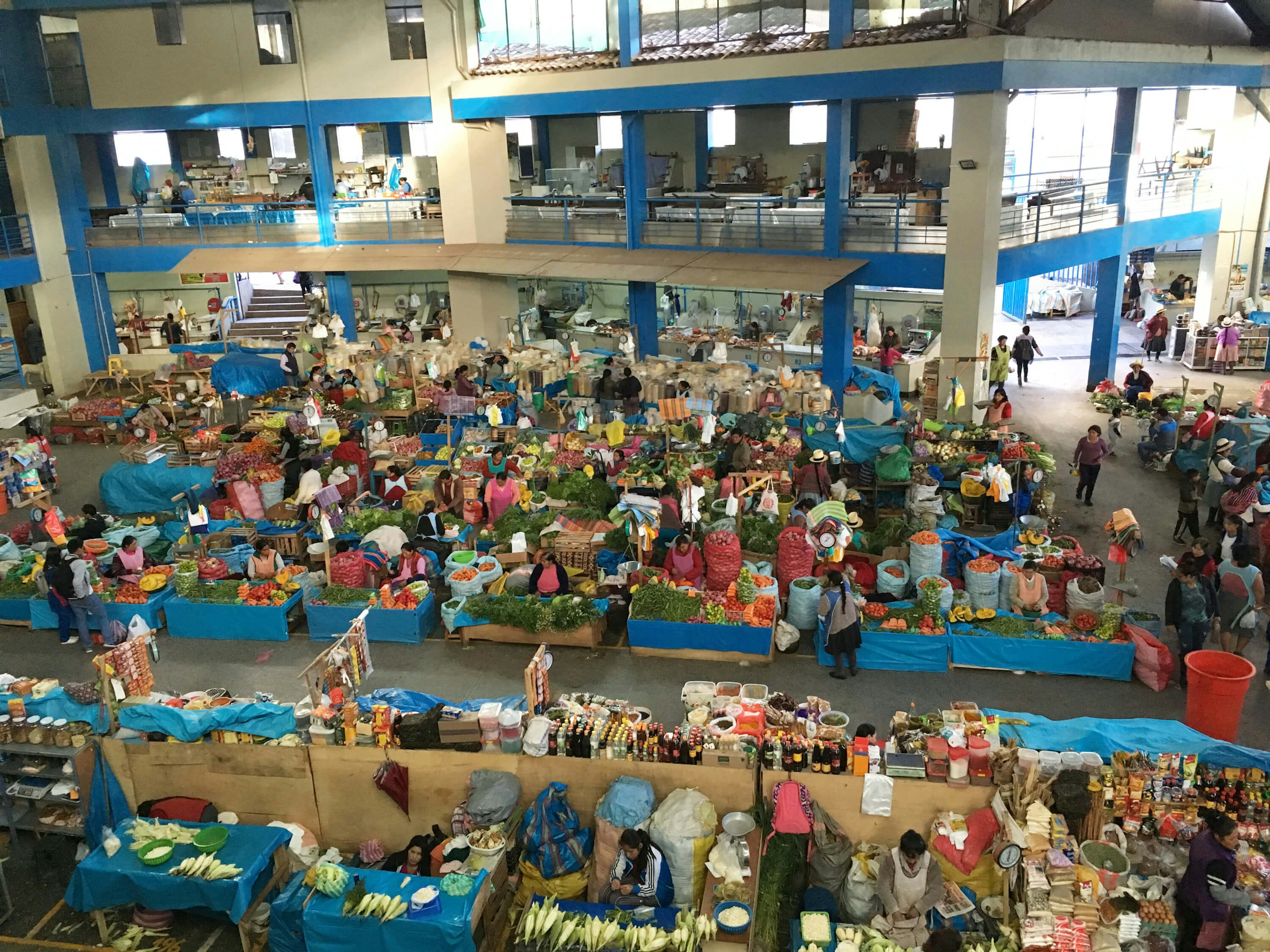 Dozens of colourful fruit and veg stalls photographed from above