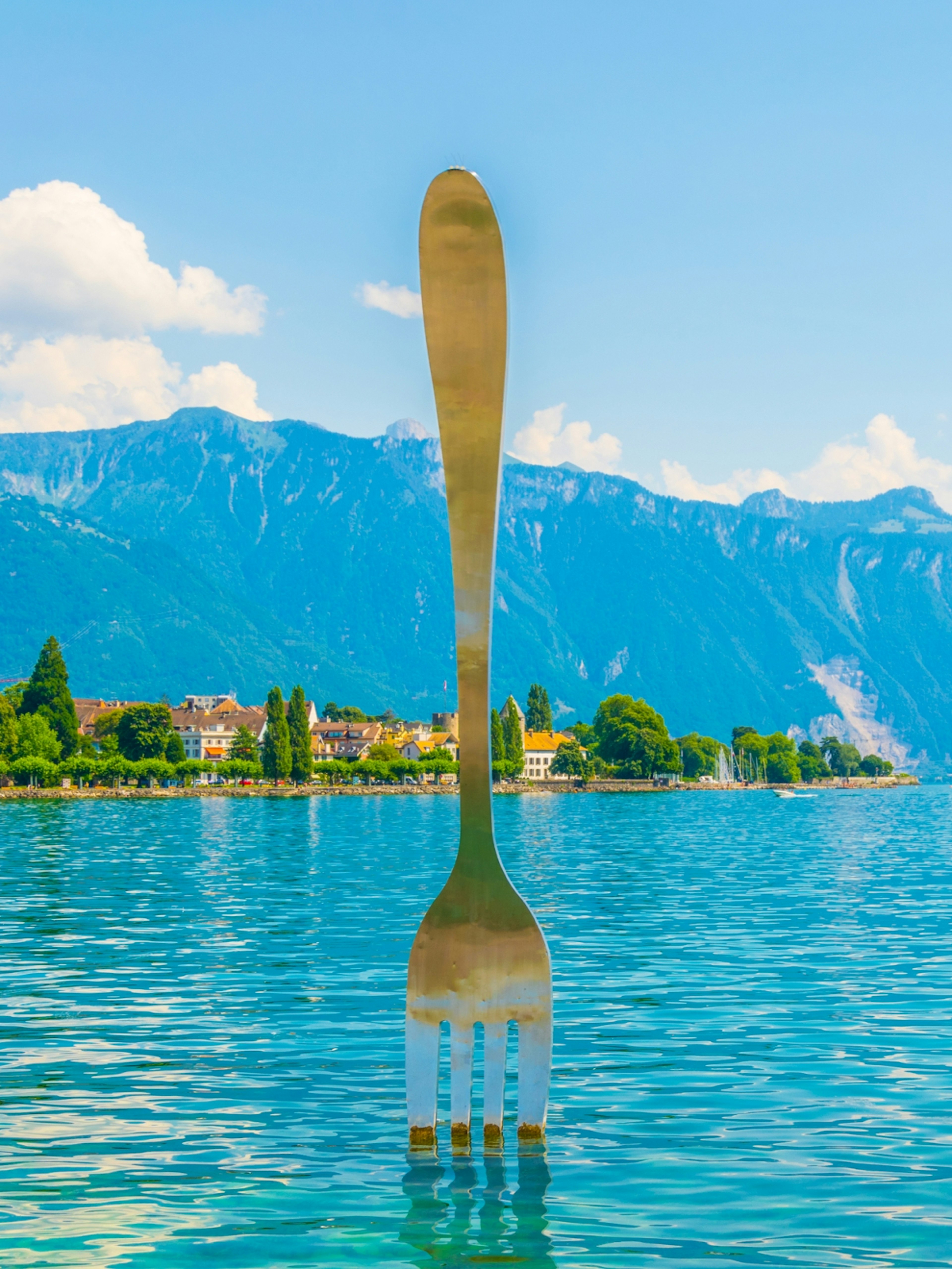 A giant fork statue rising from Lake Geneva at foodie-focused Vevey