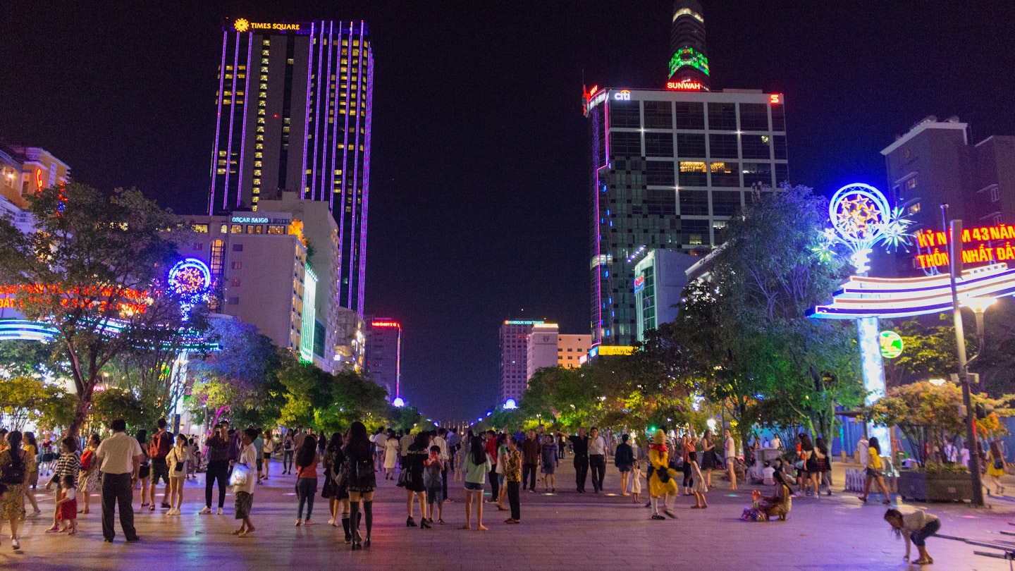 People walking on pedestrianized Nguyen Hue street in Ho Chi Minh City.
