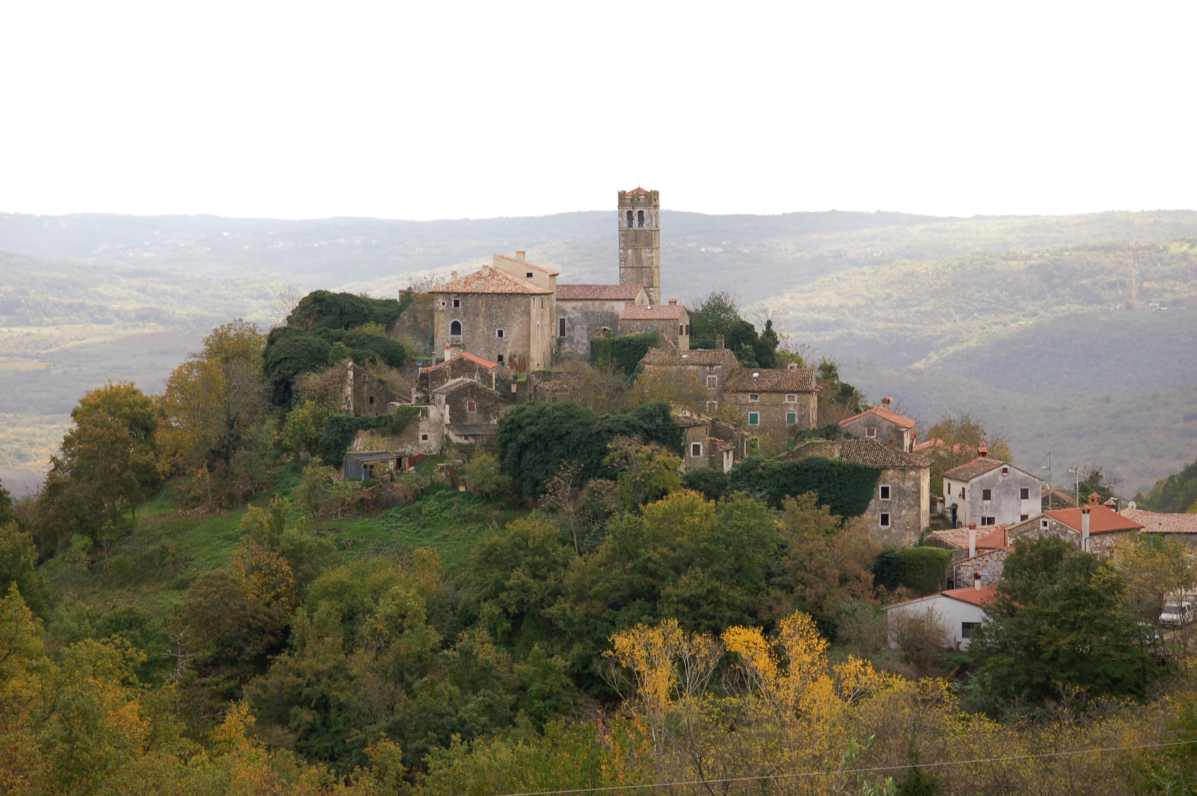 The medieval town of Zavrsje is perched on a hillside in Croatia, the house sand other buildings seeming to pour down from the highest point where the bell tower sits