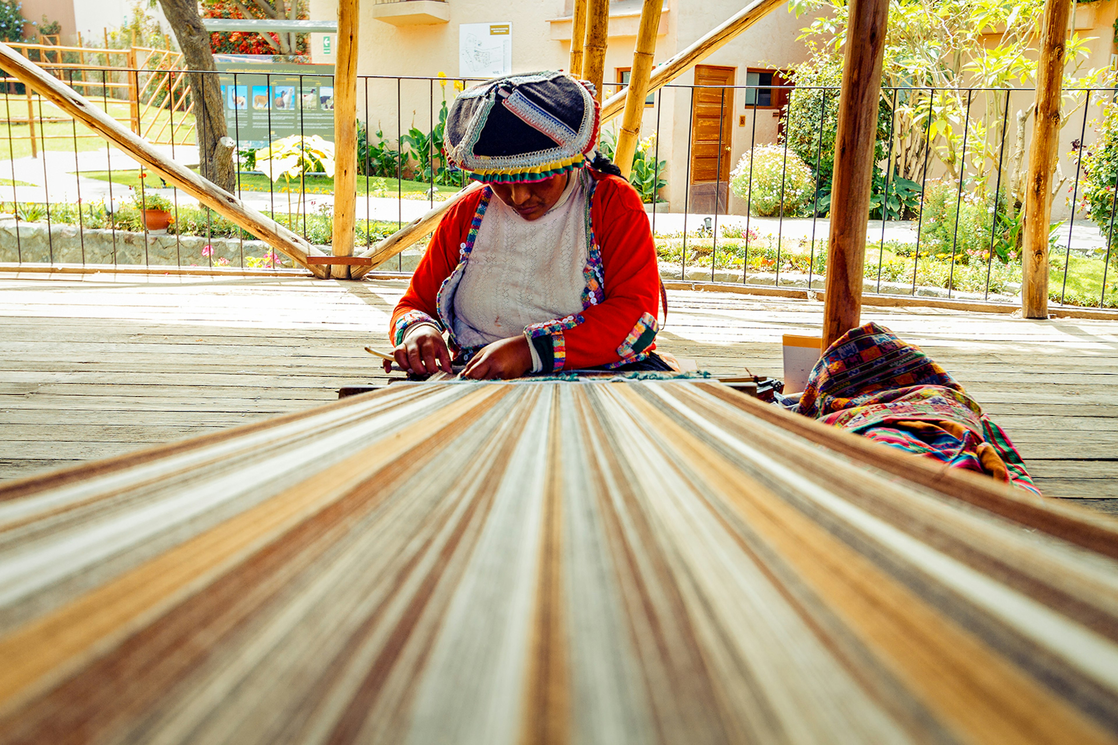 A Peruvian woman weaves on a loom in Arequipa