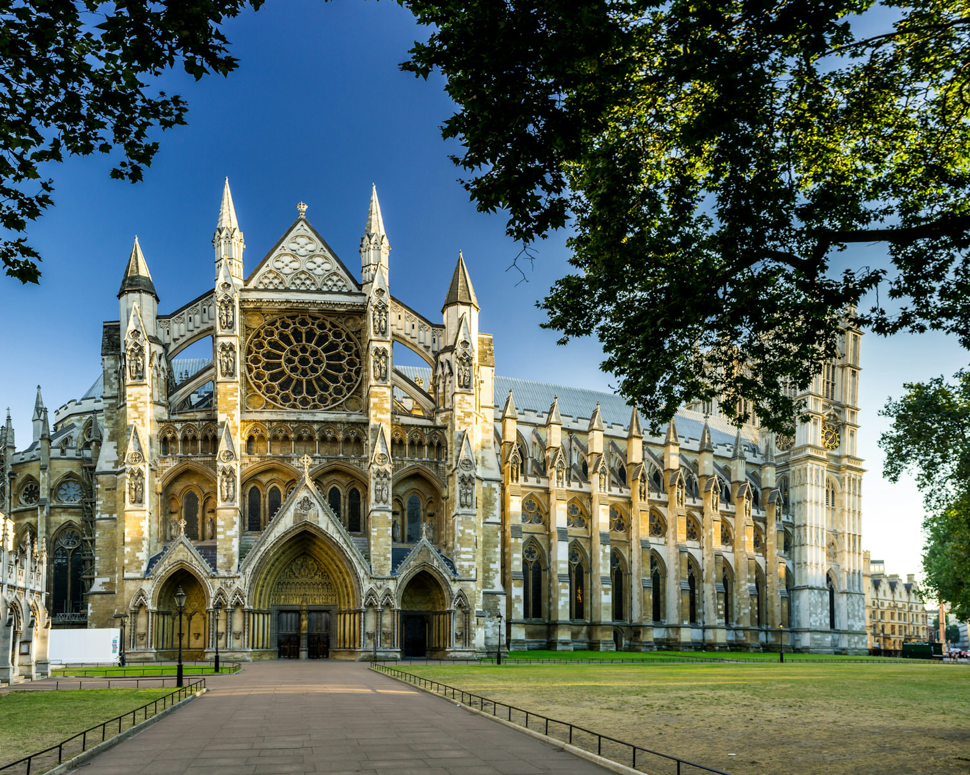 Looking down a pedestrian path to the side entrance of Westminster Abbey, with its flying buttresses, stained glass windows and pointy towers; it's been the sight of many a royal wedding © Grzegorz_Pakula / Shutterstock