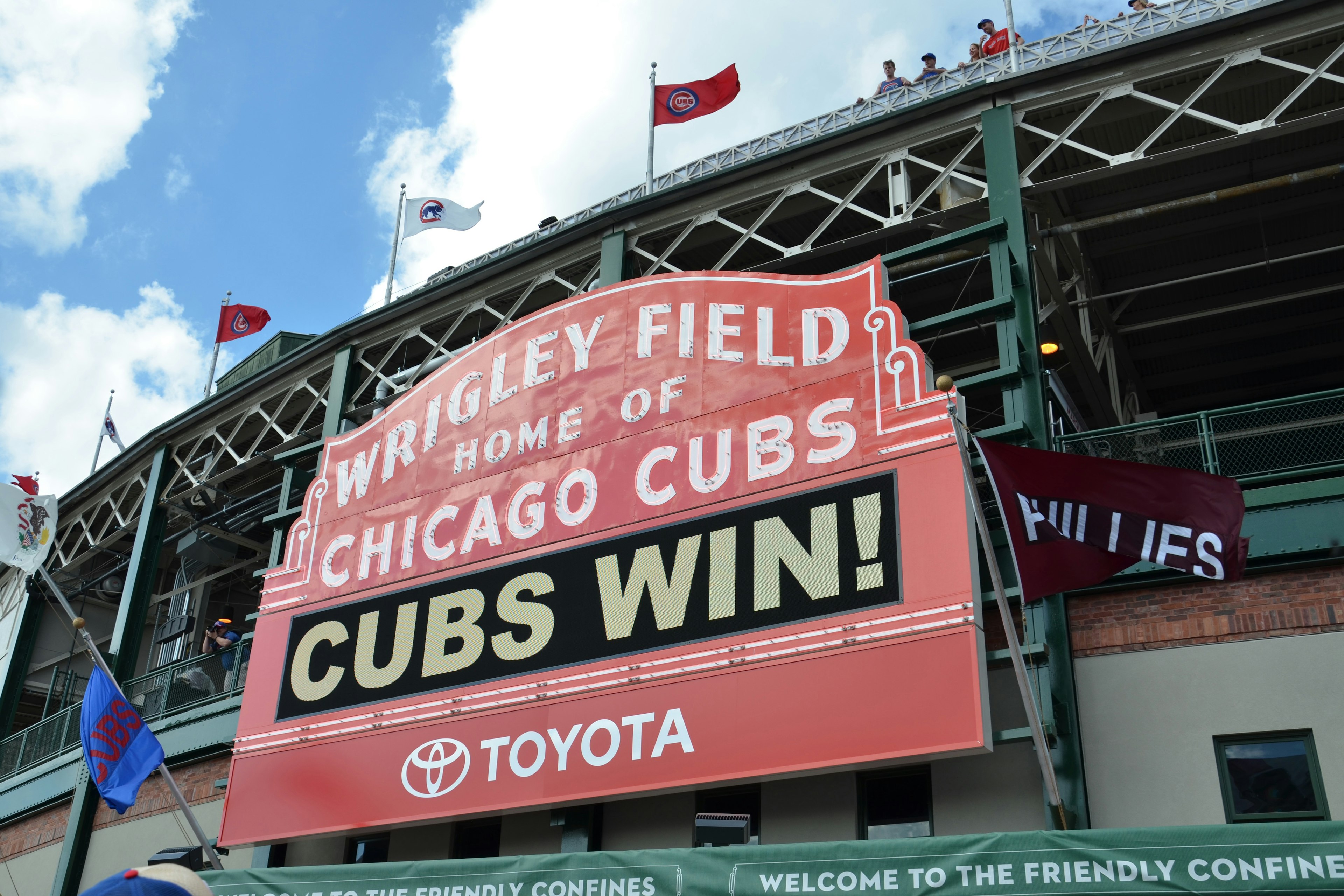 The iconic red and white sign on the Wrigley Field facade announces it as the home of the Chicago Cubs; Perfect weekend in Chicago