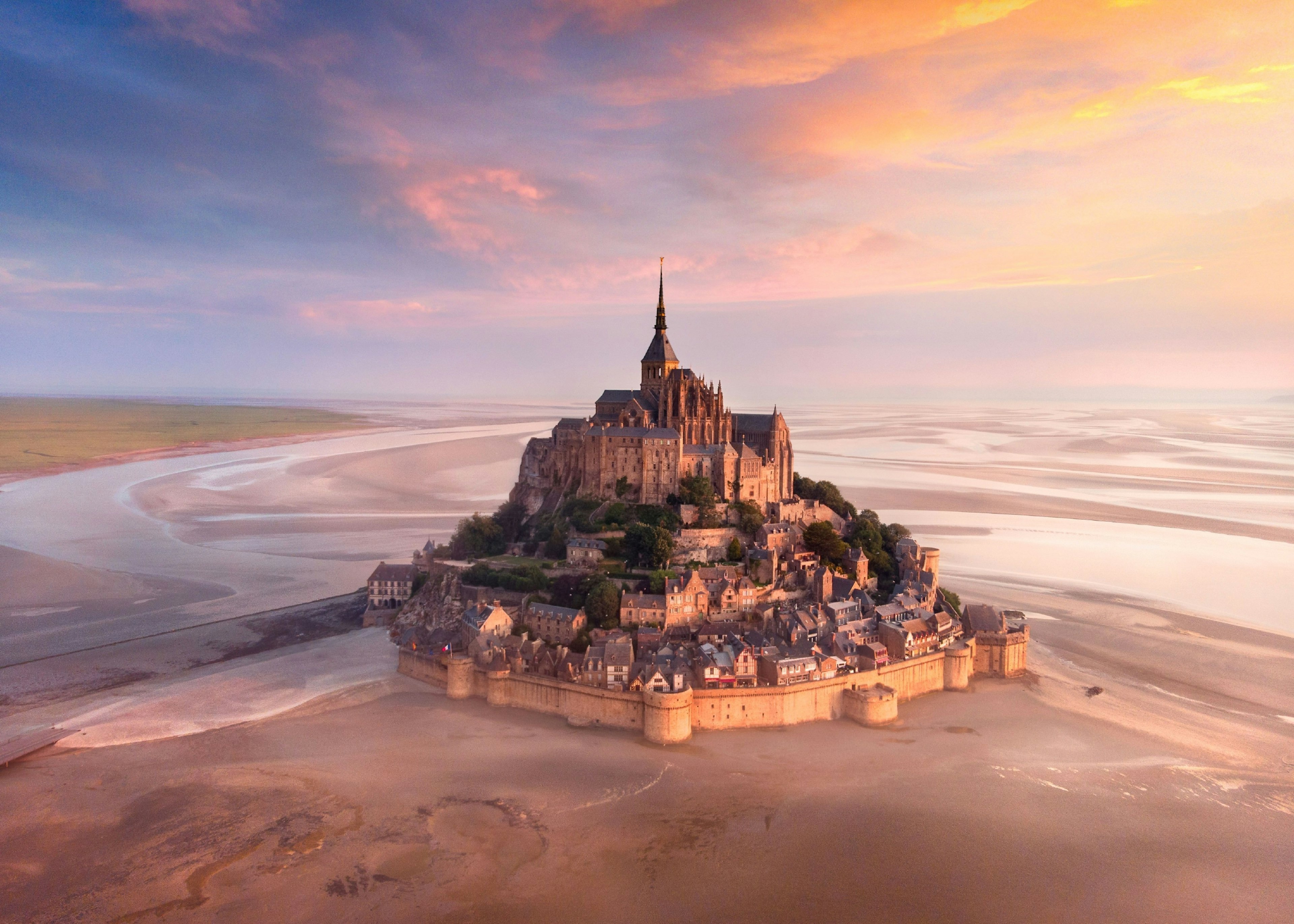 Sunrise over the monastery of Mont Saint-Michel.