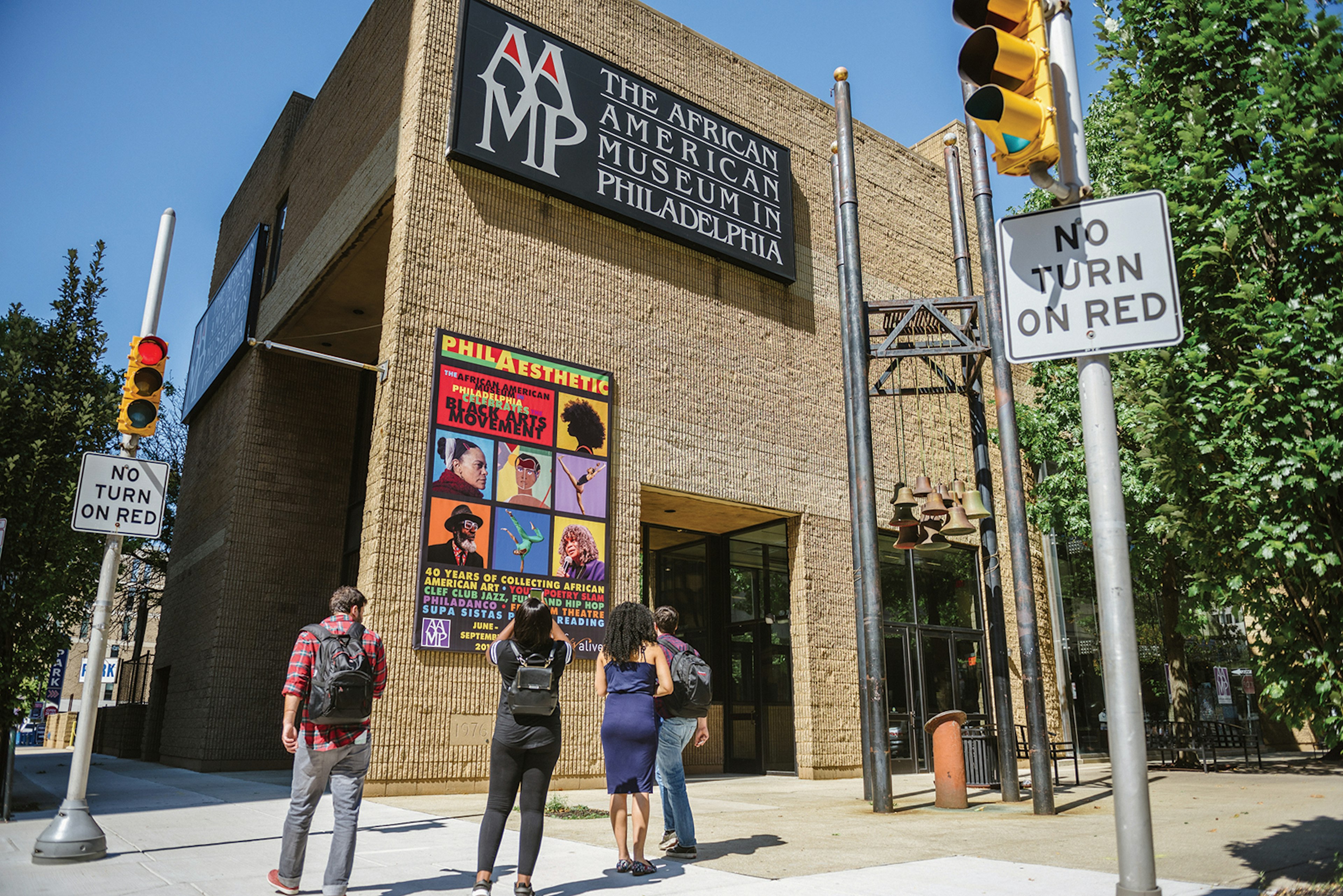 exterior shot of the light brick facade of the African American History Museum in Philadelphia on a sunny day © VISIT PHILADELPHIA®