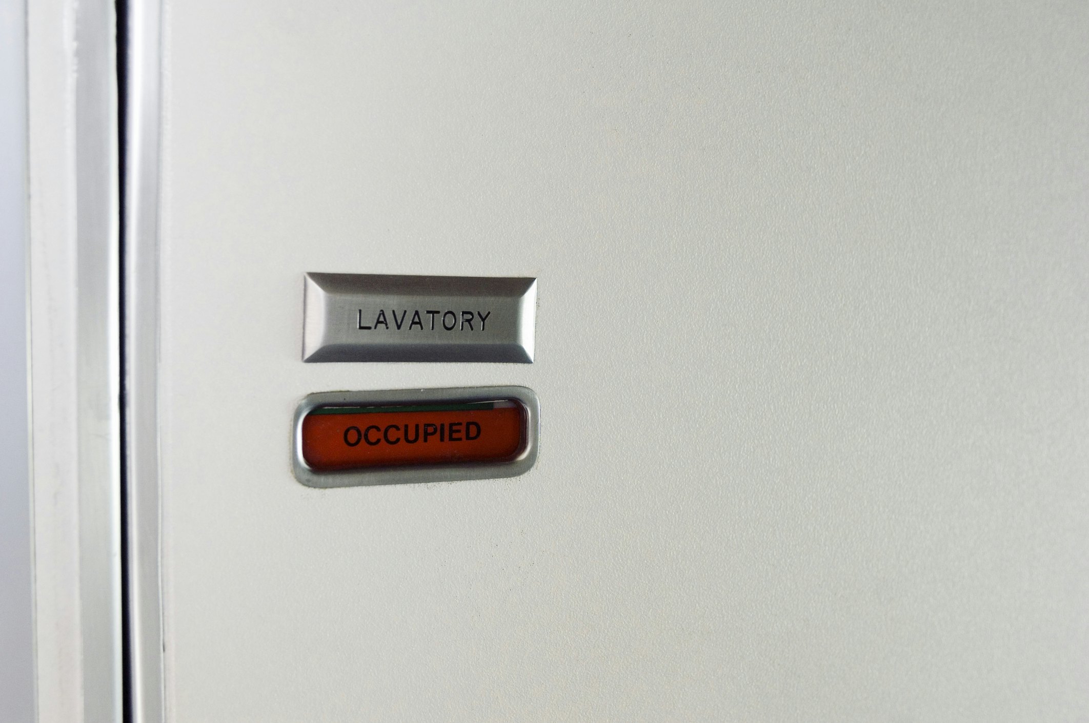 the occuped sign of an airplane toilet.