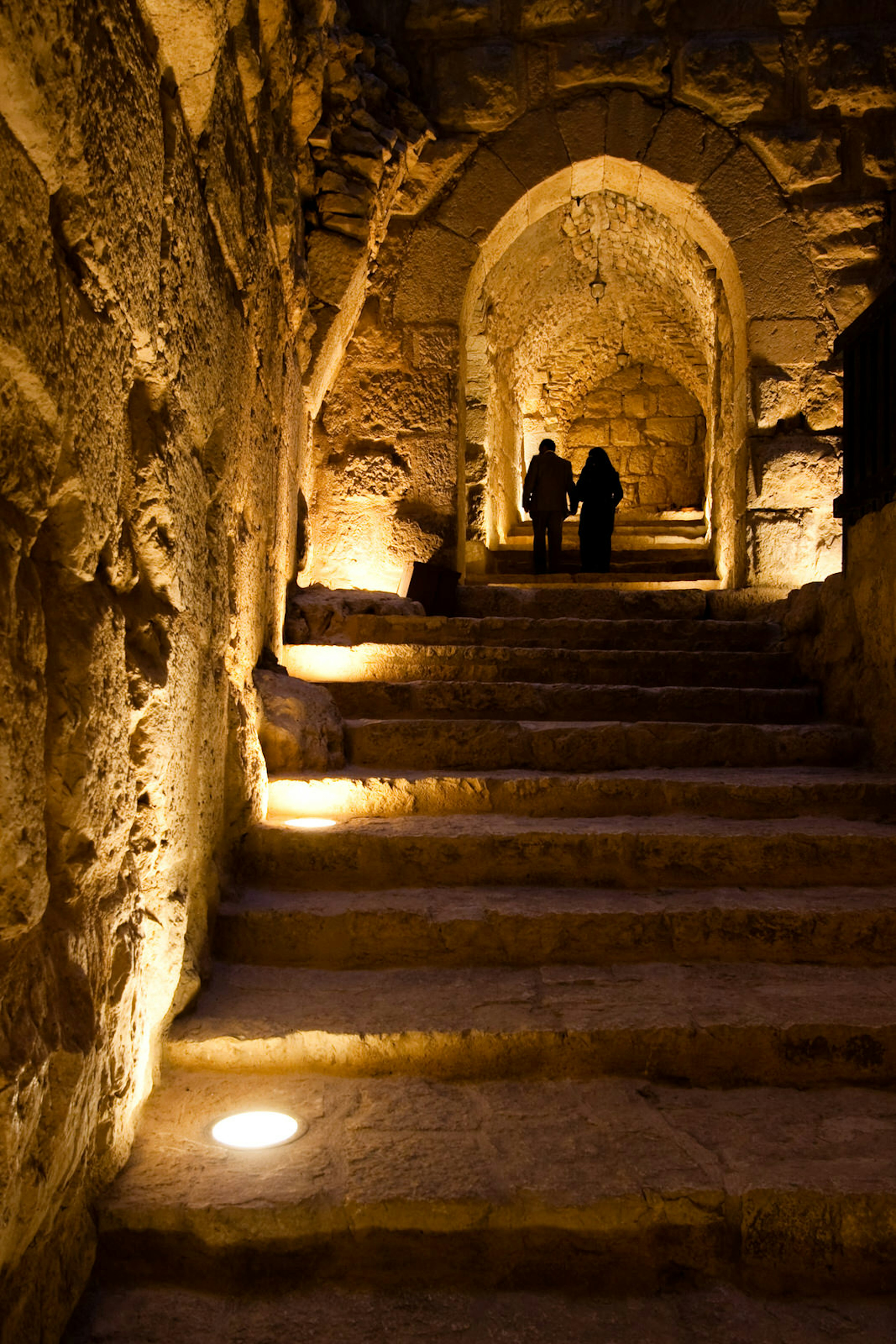 Two people walking up the stairs in the Ajloun Castle, Jordan © vkovalcik / Getty Images