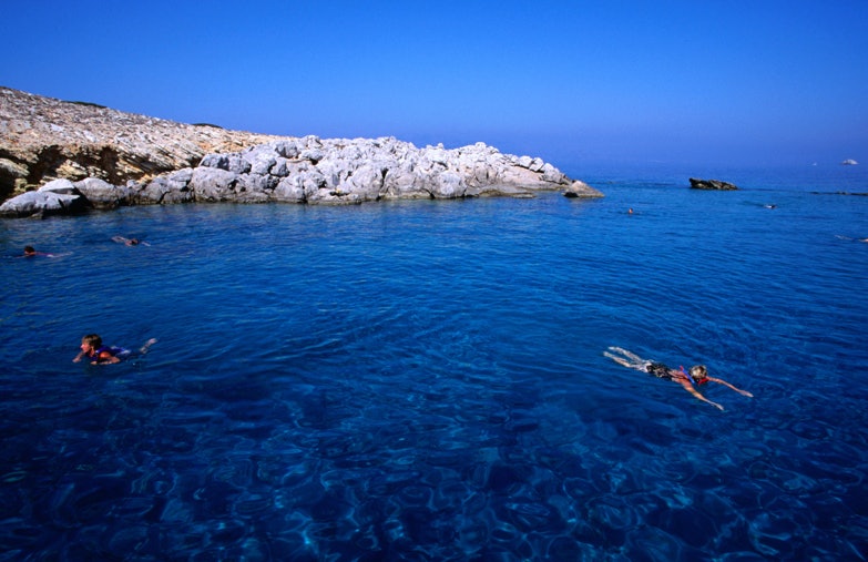 Go swimming in Greece. Image by Wayne Walton / Getty Images.