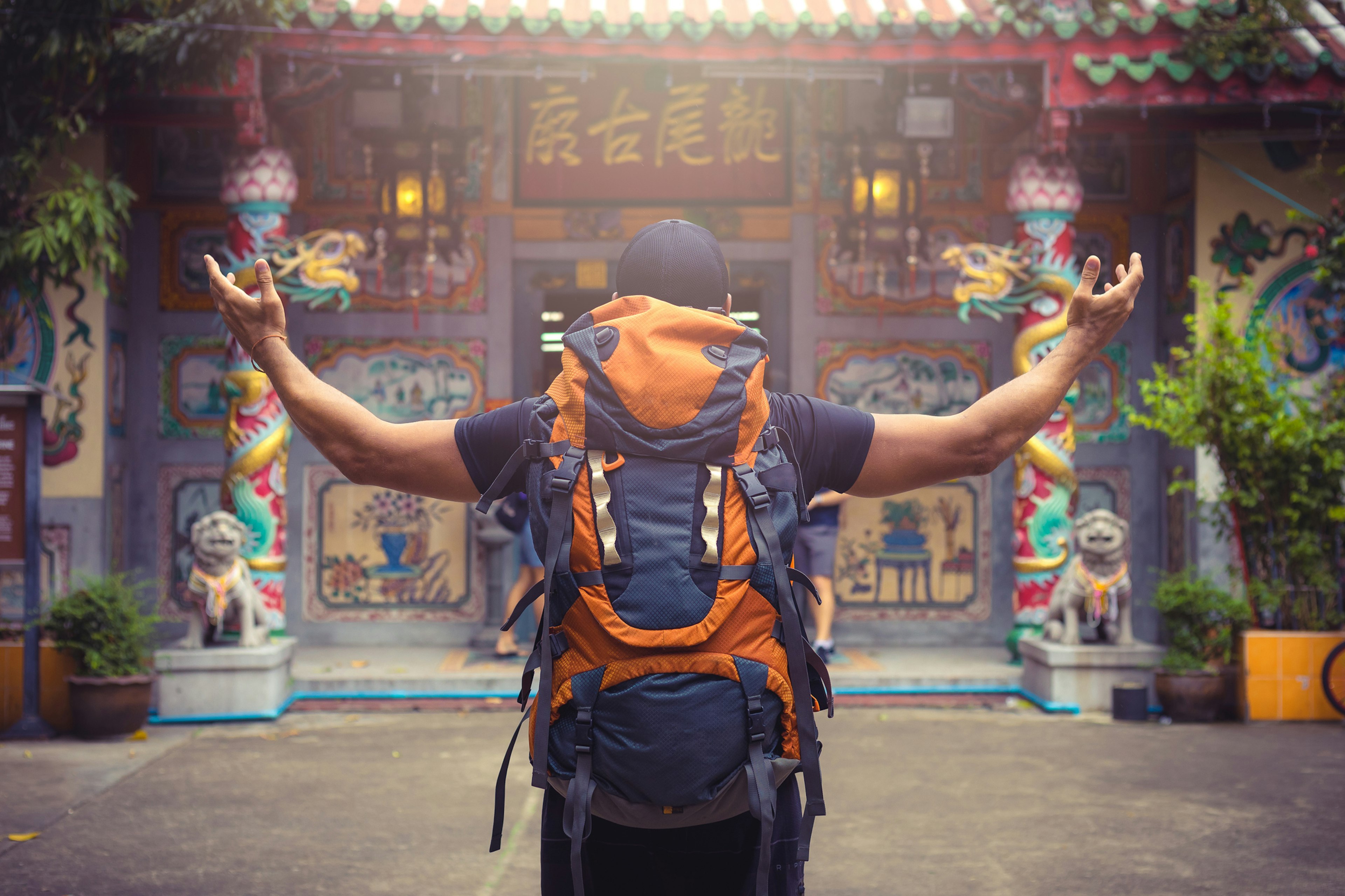 A picture of a backpacker in front of a door in Bangkok