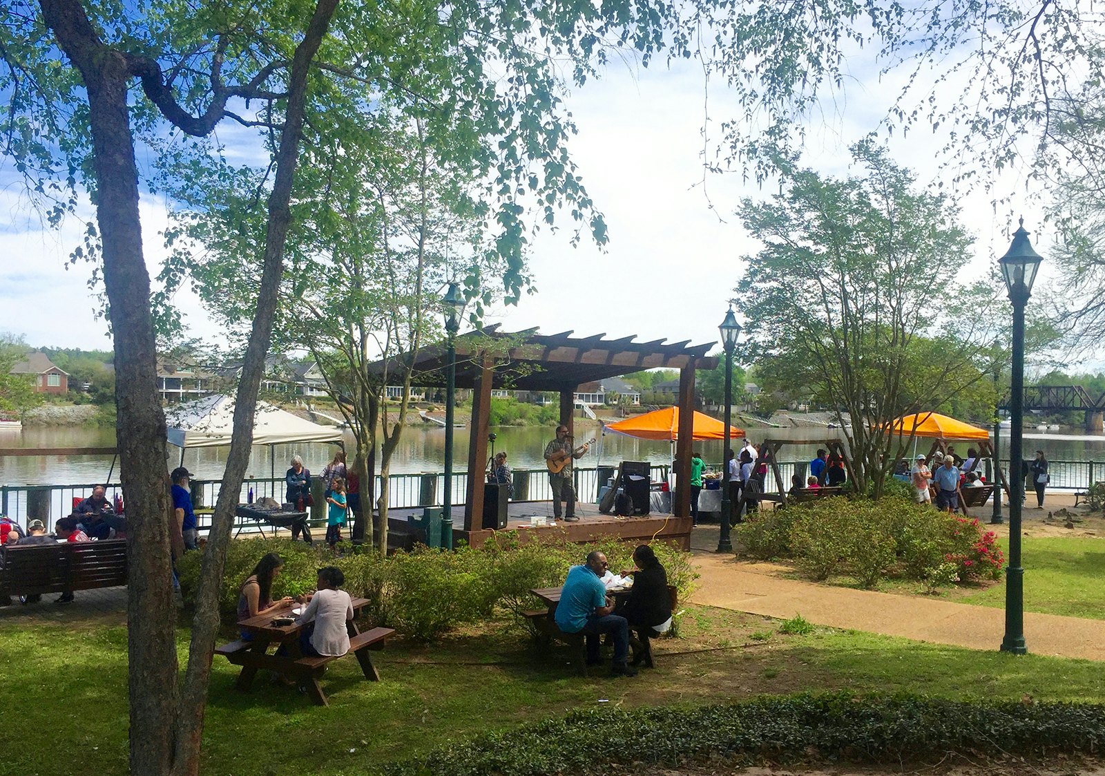 A musician performs under a pergola on Augusta's Riverwalk