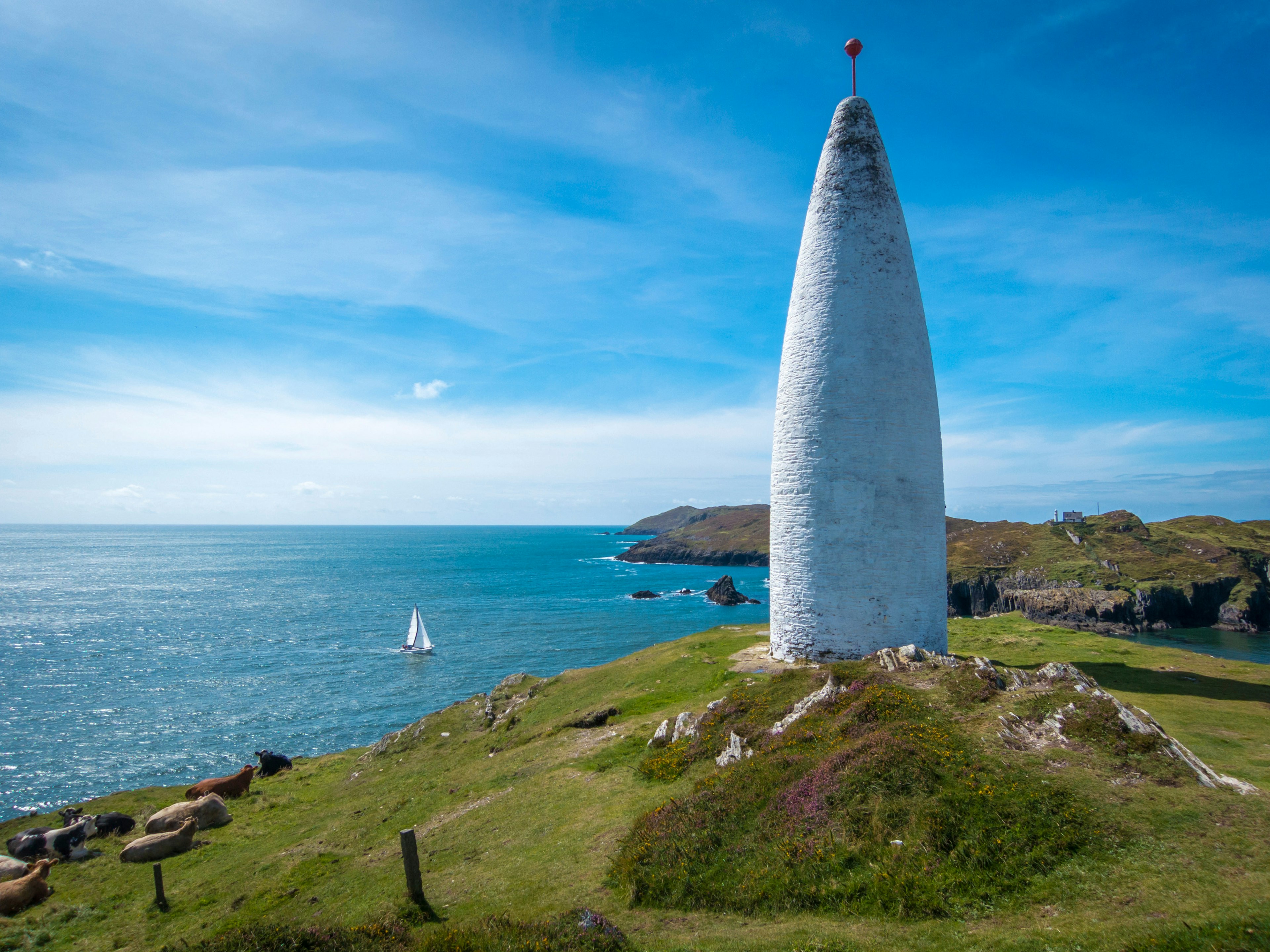 A white, conical structure on a coast