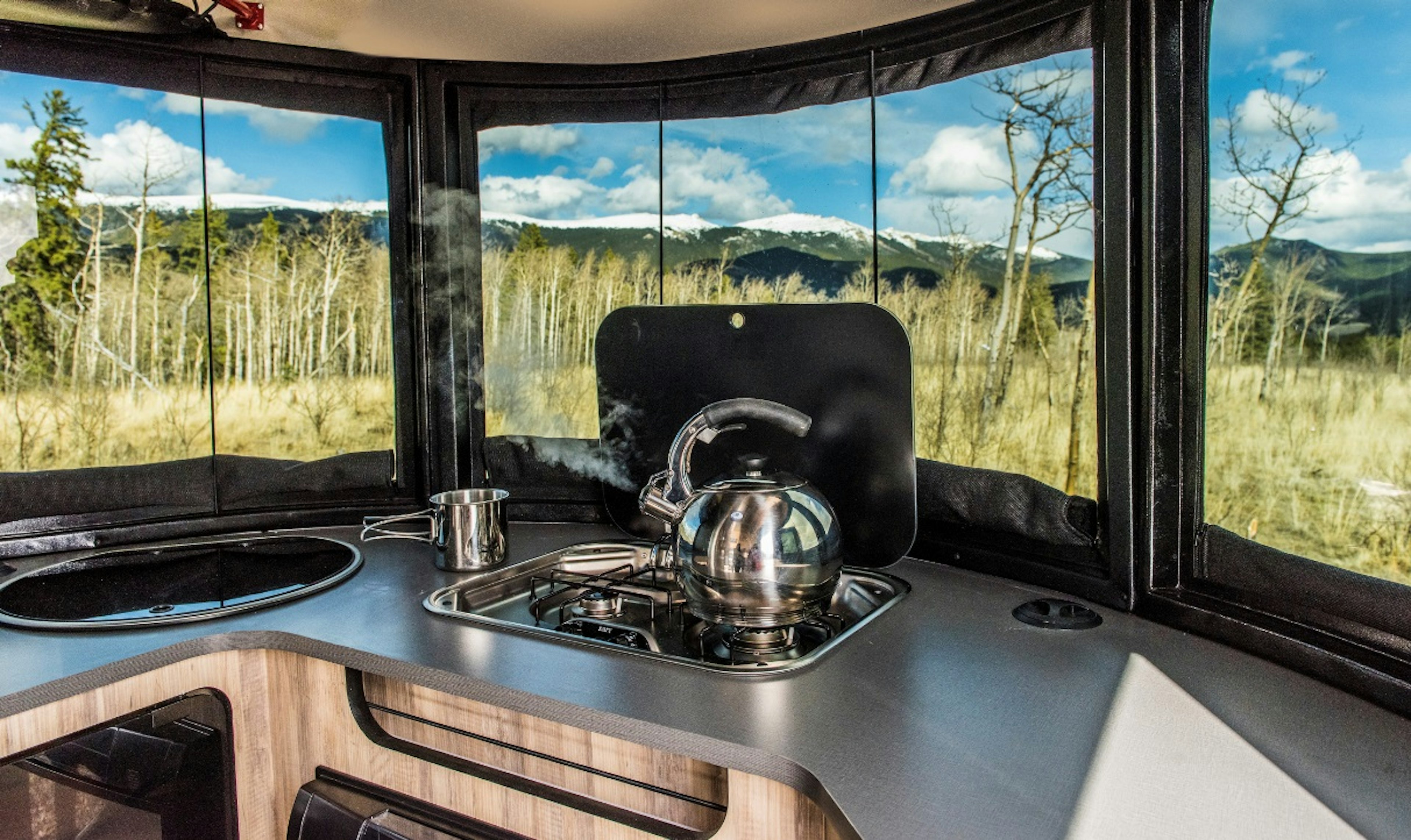 A kettle boils in the trailer's kitchen.