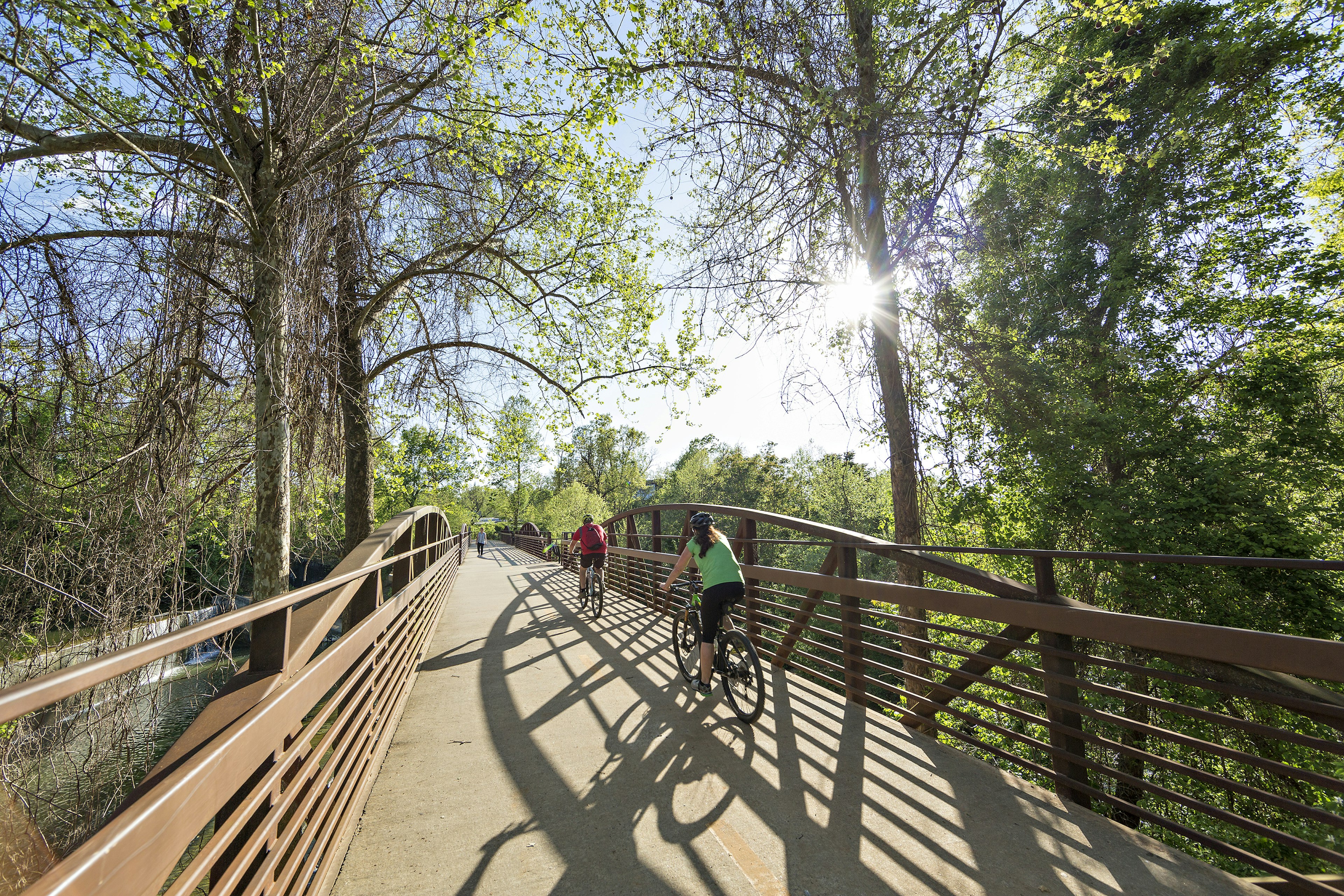 bikers use the Razorback Greenway over the dam at Lake Fayetteville in Northwest Arkansas on a sunny day with whit clouds
670648702
Greenway