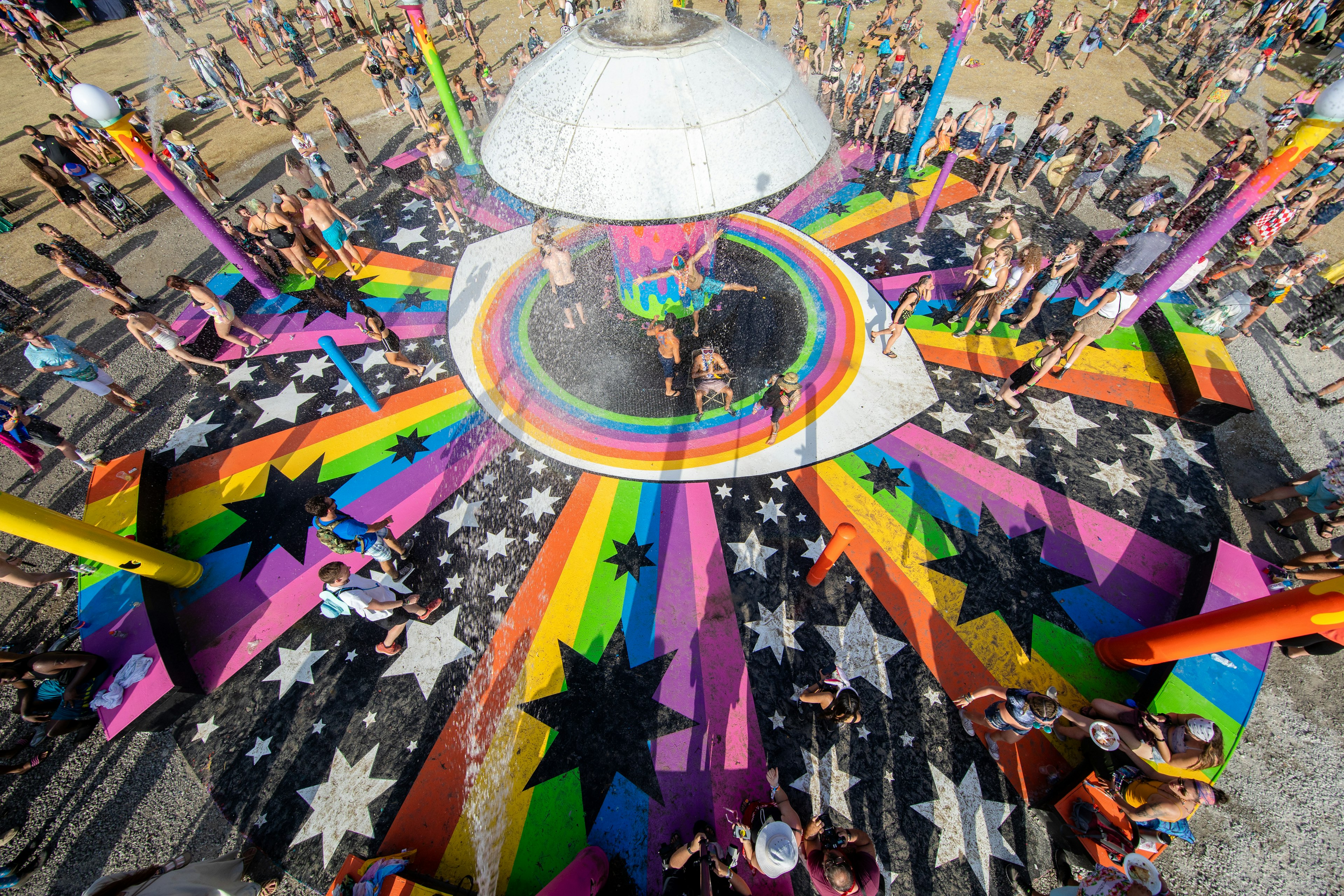 Festival goers cool off in a water fountain at Bonnaroo Music and Arts Festival