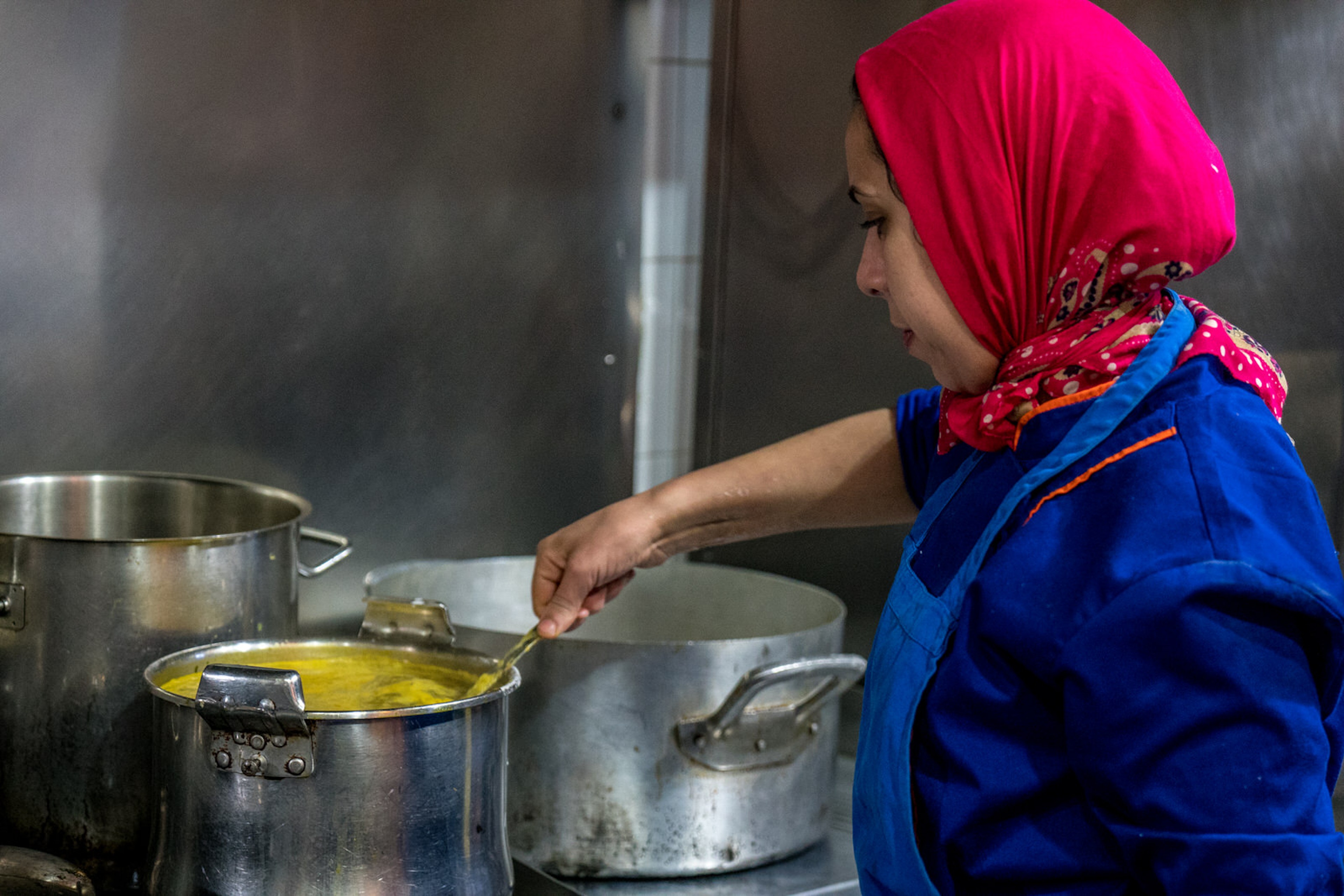 Moroccan chef cooking at The Clock Kitchen. Image by Justin Mauldin / Café Clock