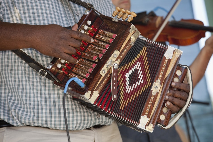 Cajun band playing at the Festivals Acadiens et Creoles in Lafayette. Image by Judy Bellah / Lonely Planet Images / Getty Images