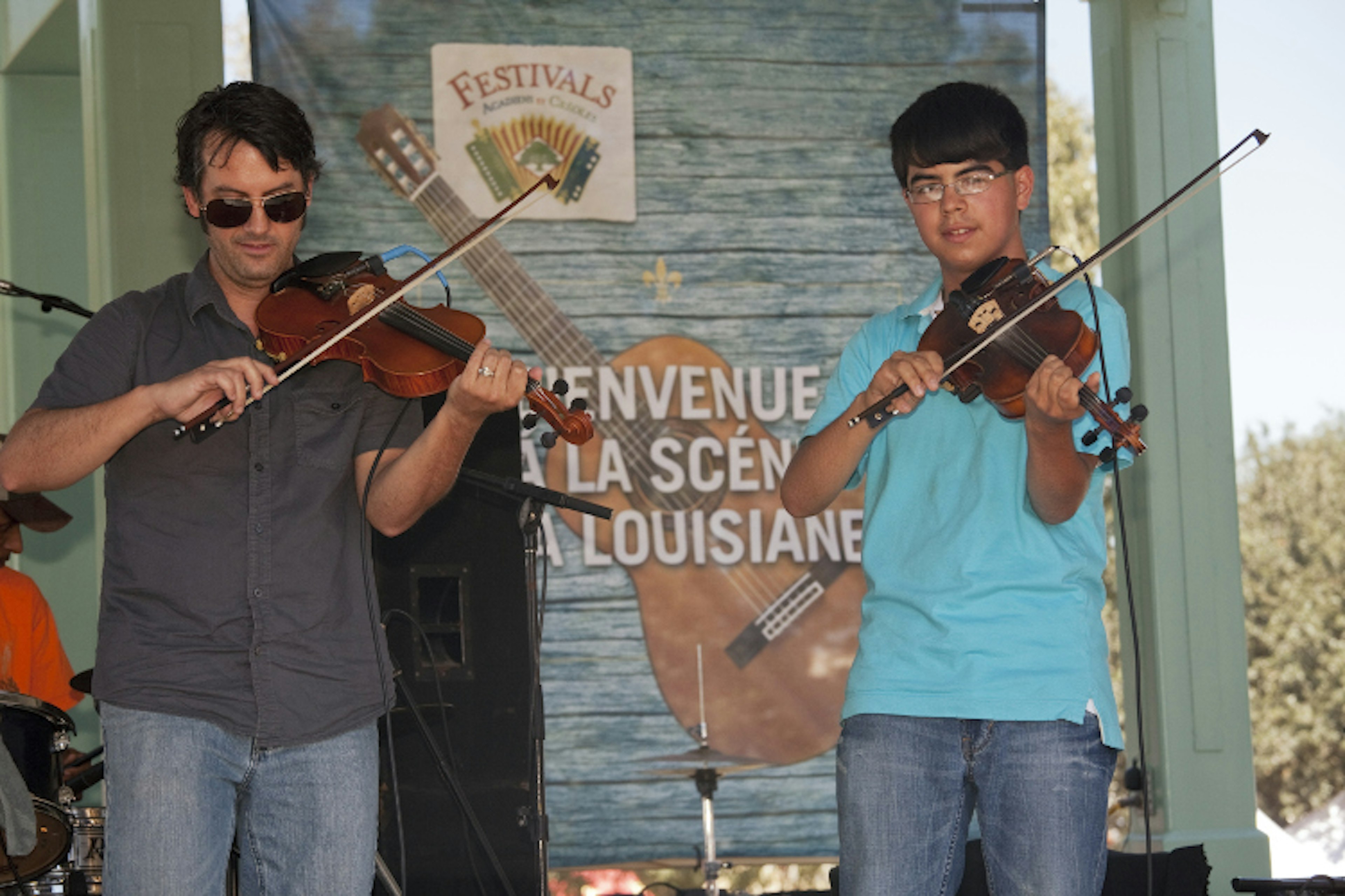 Cajun fiddles playing at the Festivals Acadiens et Creoles. Image by Judy Bellah / ϰϲʿ¼ Images / Getty Images