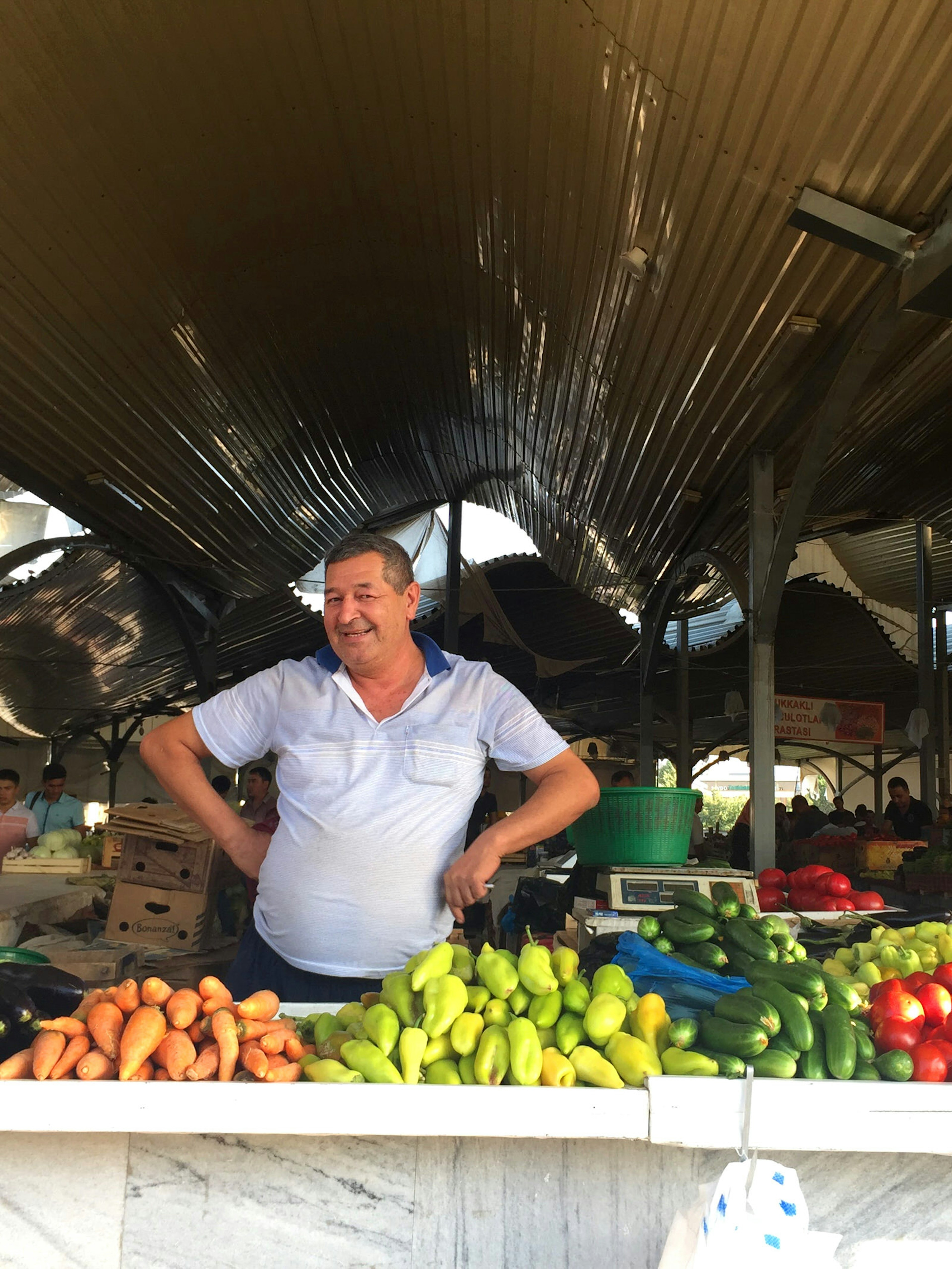 Friendly vegetable vendor in Tashkent's Chorsu Bazaar