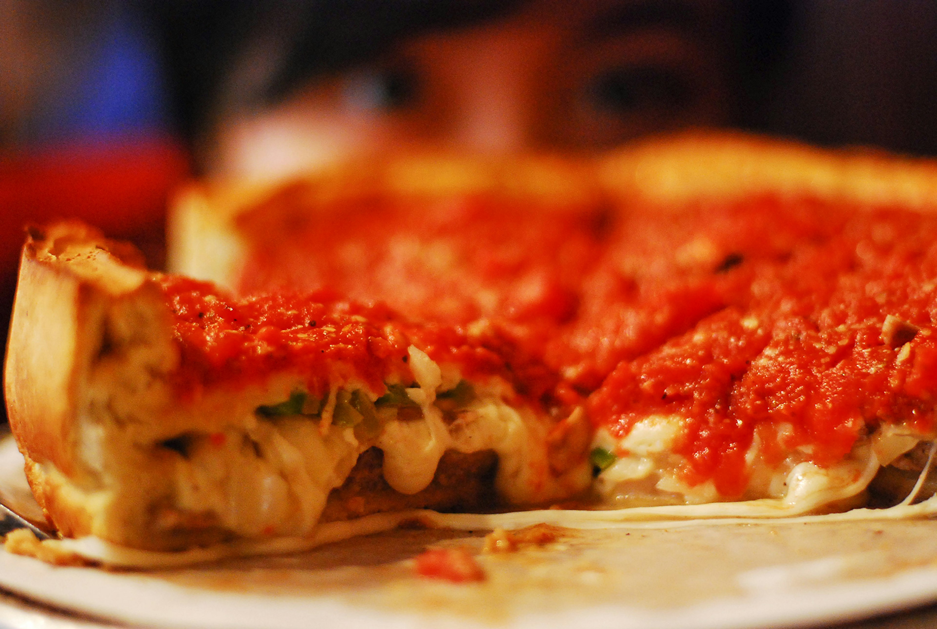 cheesy, gooey and piping hot slice of chicago pizza