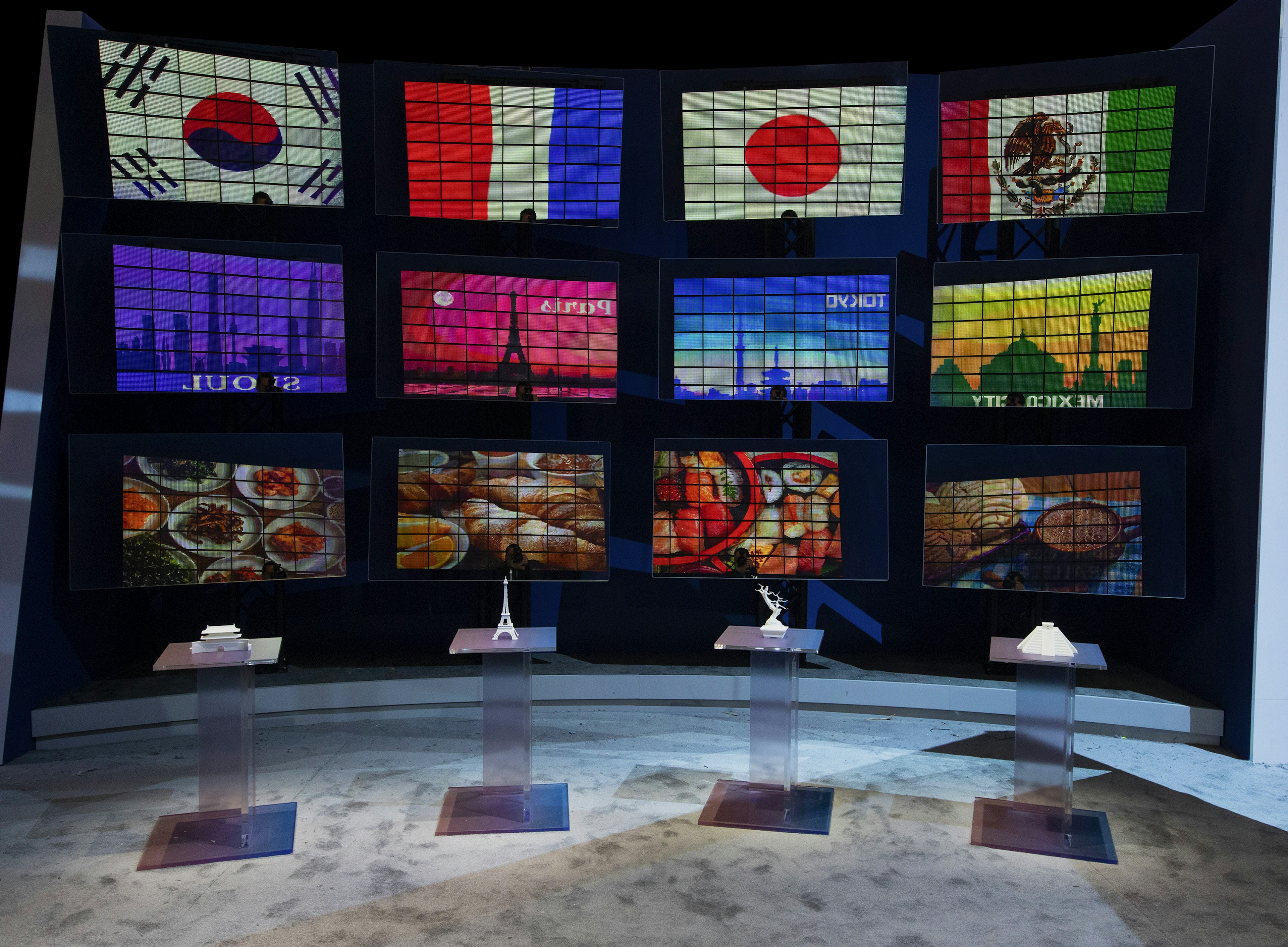 A tradeshow booth depicting flags and city skylines