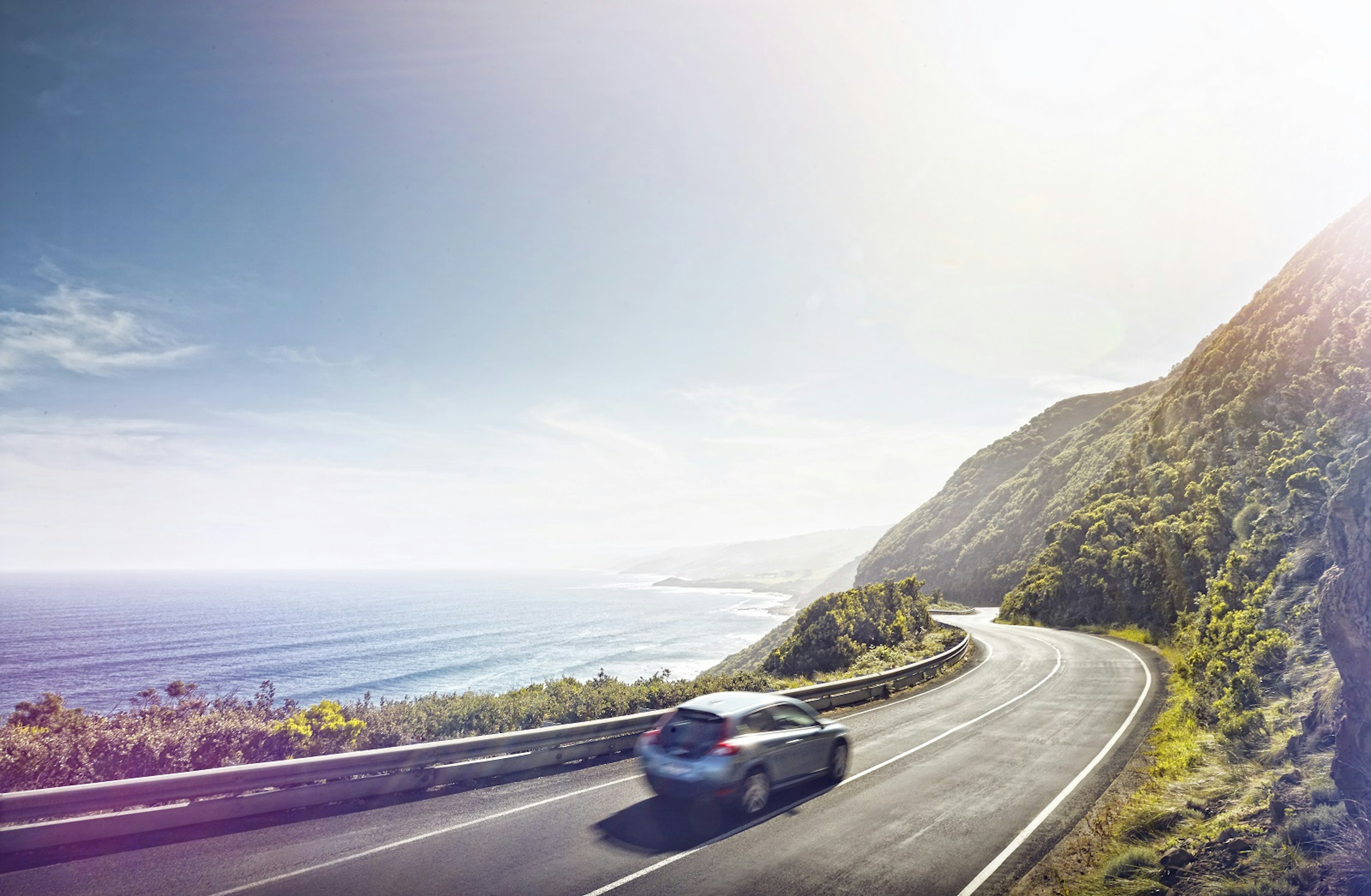 Car driving on the Great Ocean Road Australia on a sunny day