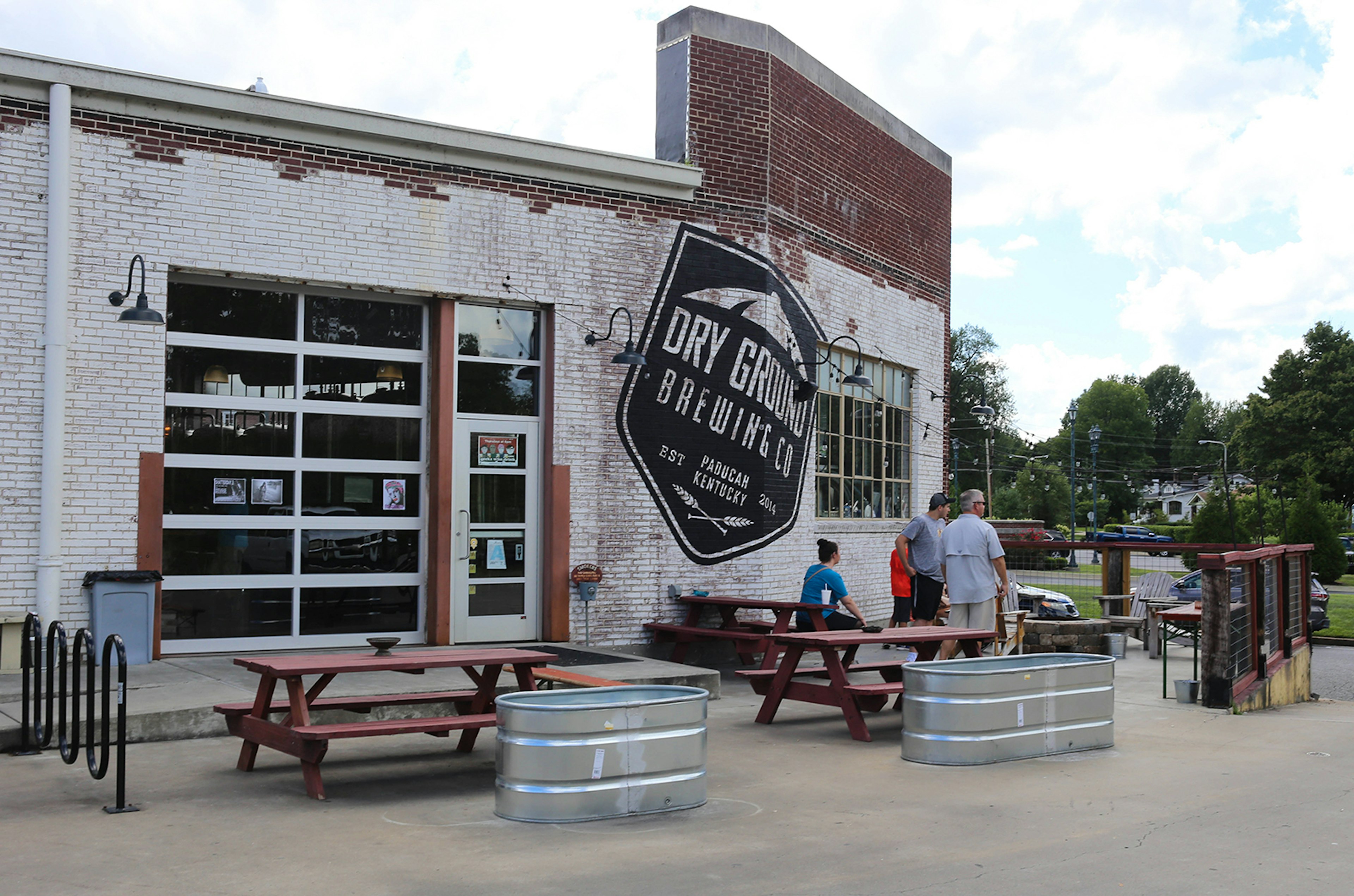 Exterior view of old industrial building reconfigured into a brewery on a partly cloudy day