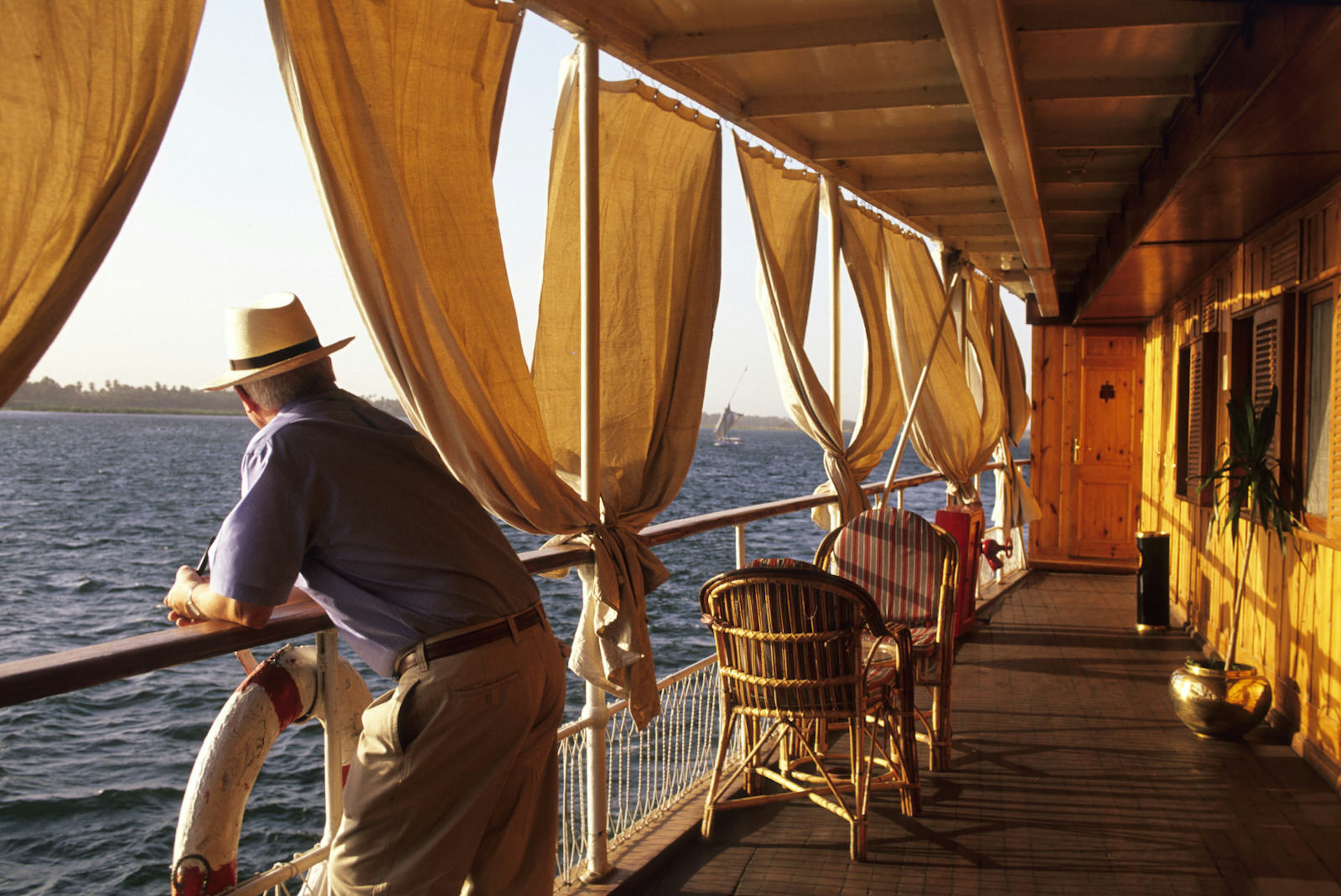 Man looking out on the Nile from a cruise Luxor and Aswan. Image by Stéphane Lemaire / hemis.fr / Getty Images