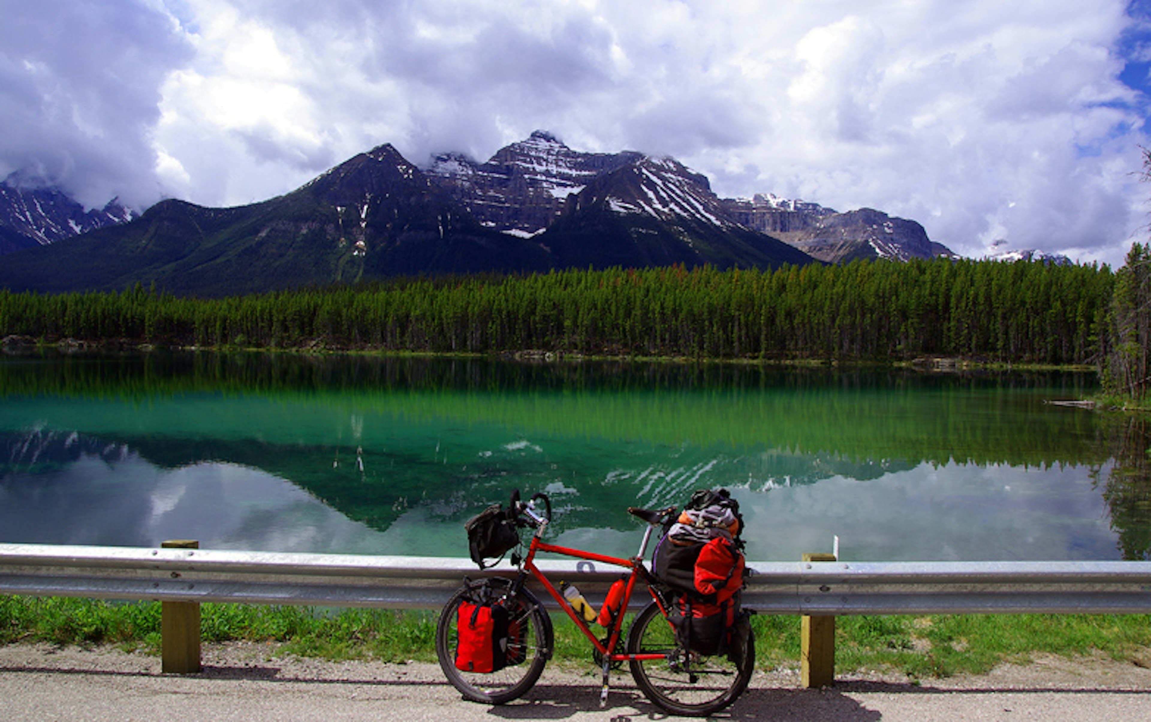 Cycling with a lake view in Banff National Park. Image by Reinhard Pantka / Flickr / Getty Images.