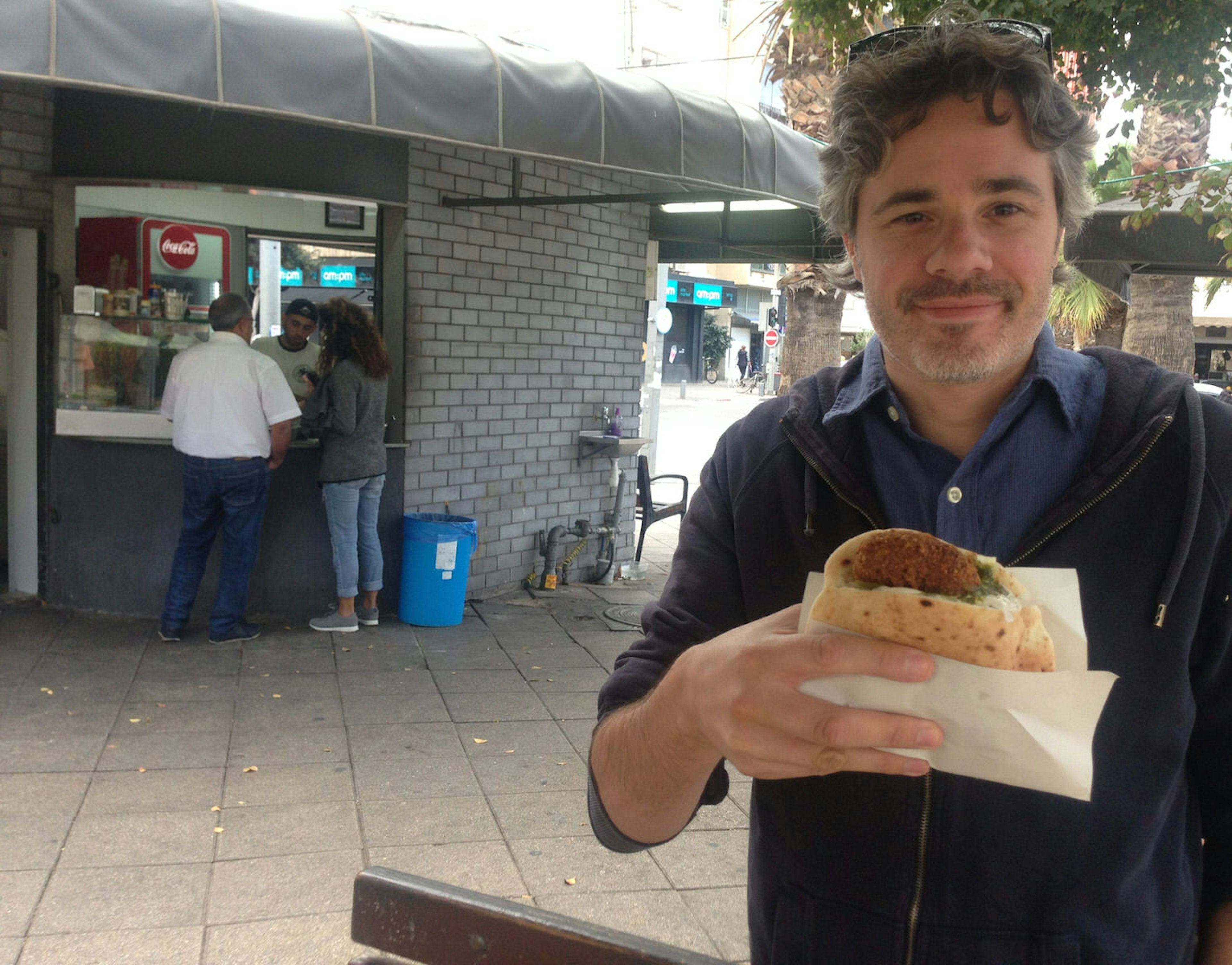 Eating a falafel in Tel Aviv. Image by Dan Savery Raz / iBestTravel