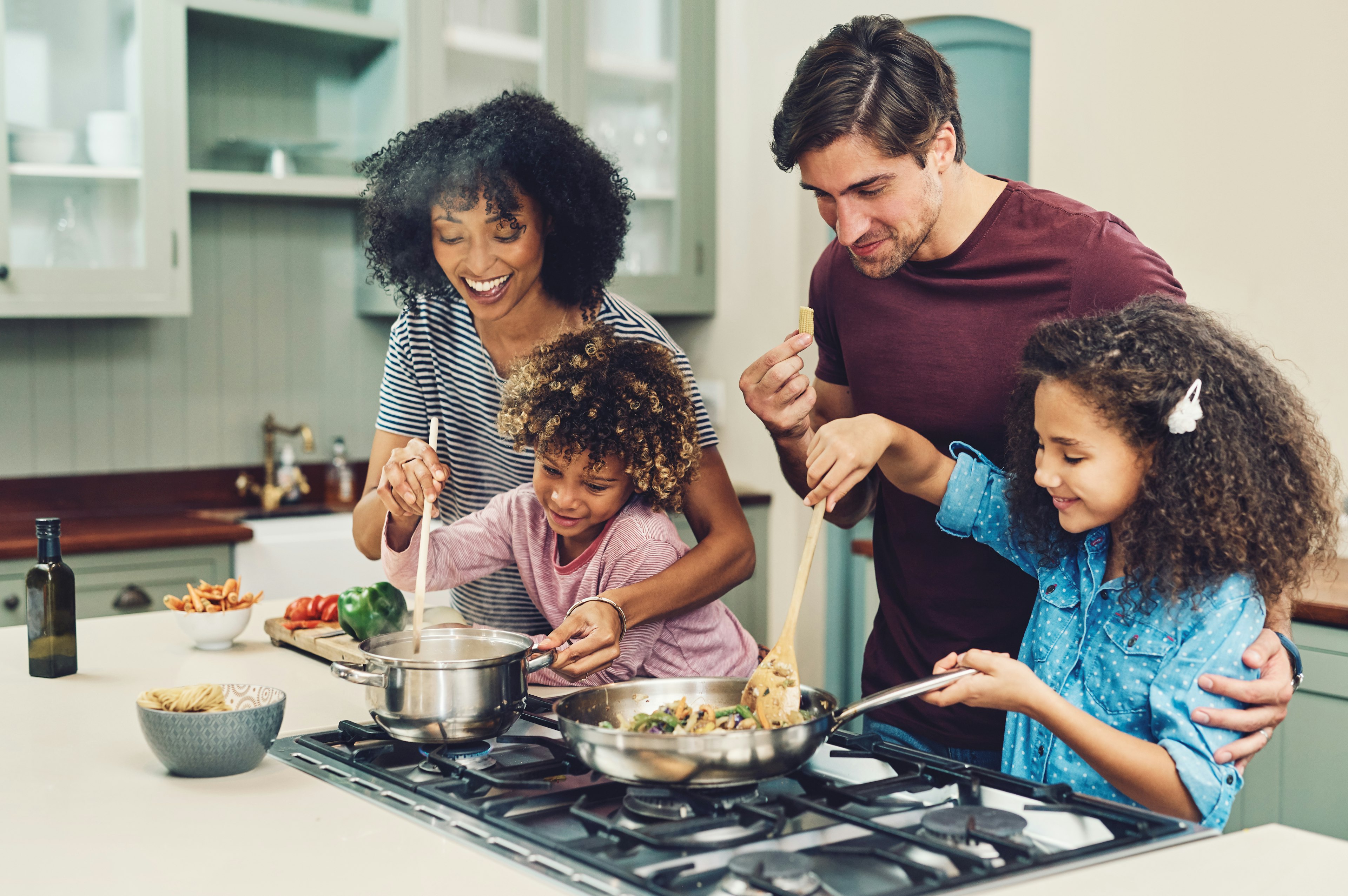 A family of four cooking together