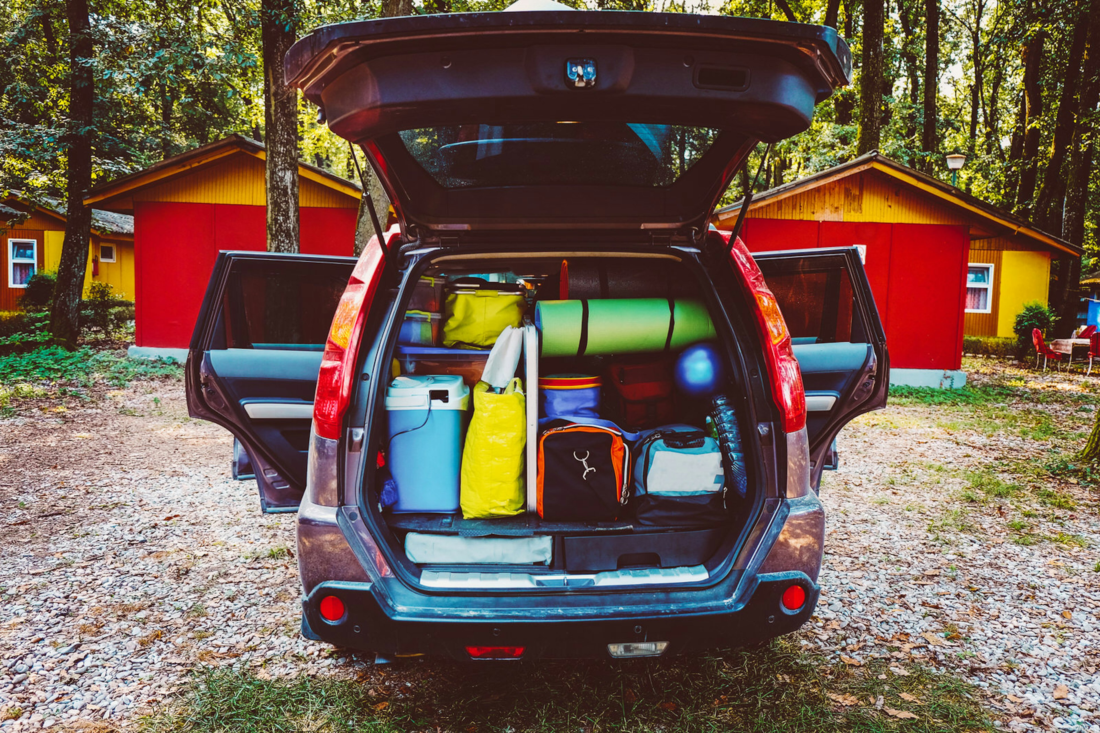 Travel car and camping luggage packed in the full car trunk. Outdoor wanderlust items. Outdoor, adventures and travel suv. Ready to go concept. Vintage hipster tone. Camping exploring.; Shutterstock ID 407042977; Your name (First / Last): Emma Sparks; GL account no.: 61025; Netsuite department name: Online Editorial; Full Product or Project name including edition: Road trip with kids article