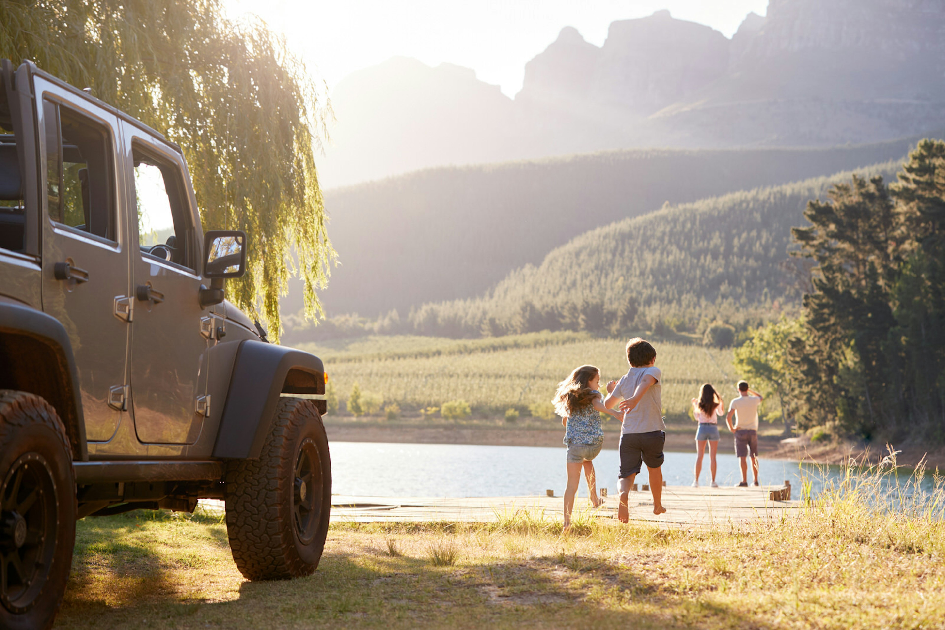 Excited Family Reaching Countryside Destination On Road Trip; Shutterstock ID 1106000942; Your name (First / Last): Emma Sparks; GL account no.: 61025; Netsuite department name: Online Editorial; Full Product or Project name including edition: Road trip with kids article