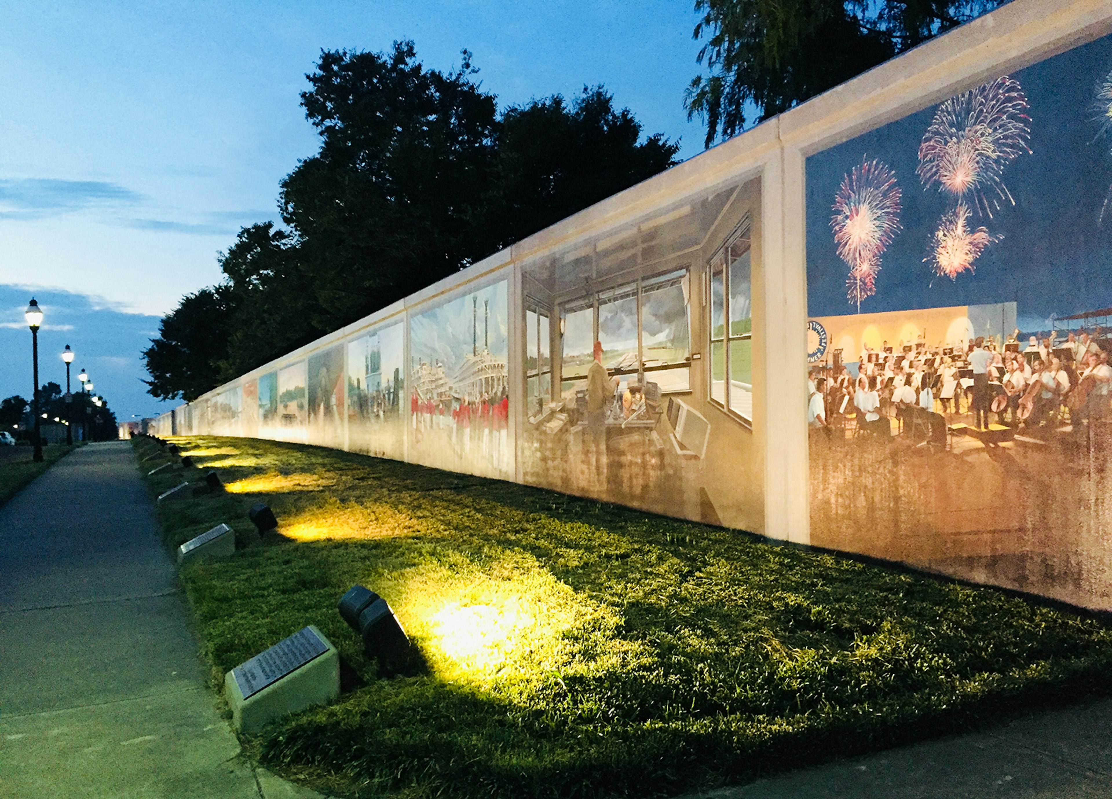 Distance shot of murals by Robert Dafford along the floodwall in Paducah, Kentucky, at dusk