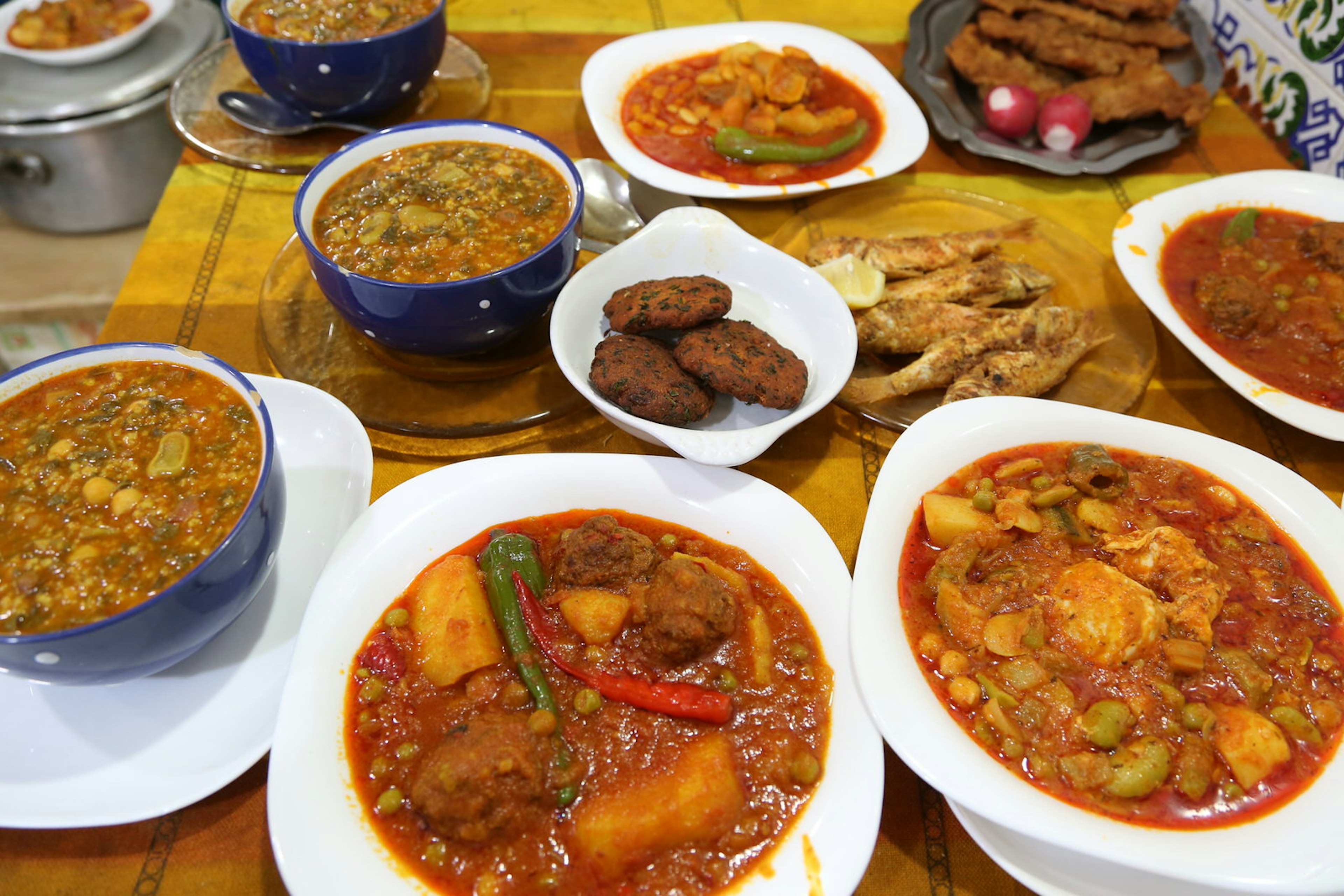 Traditional Tunisian dishes of food wait on a table at Dar Bellaaj in Sfax