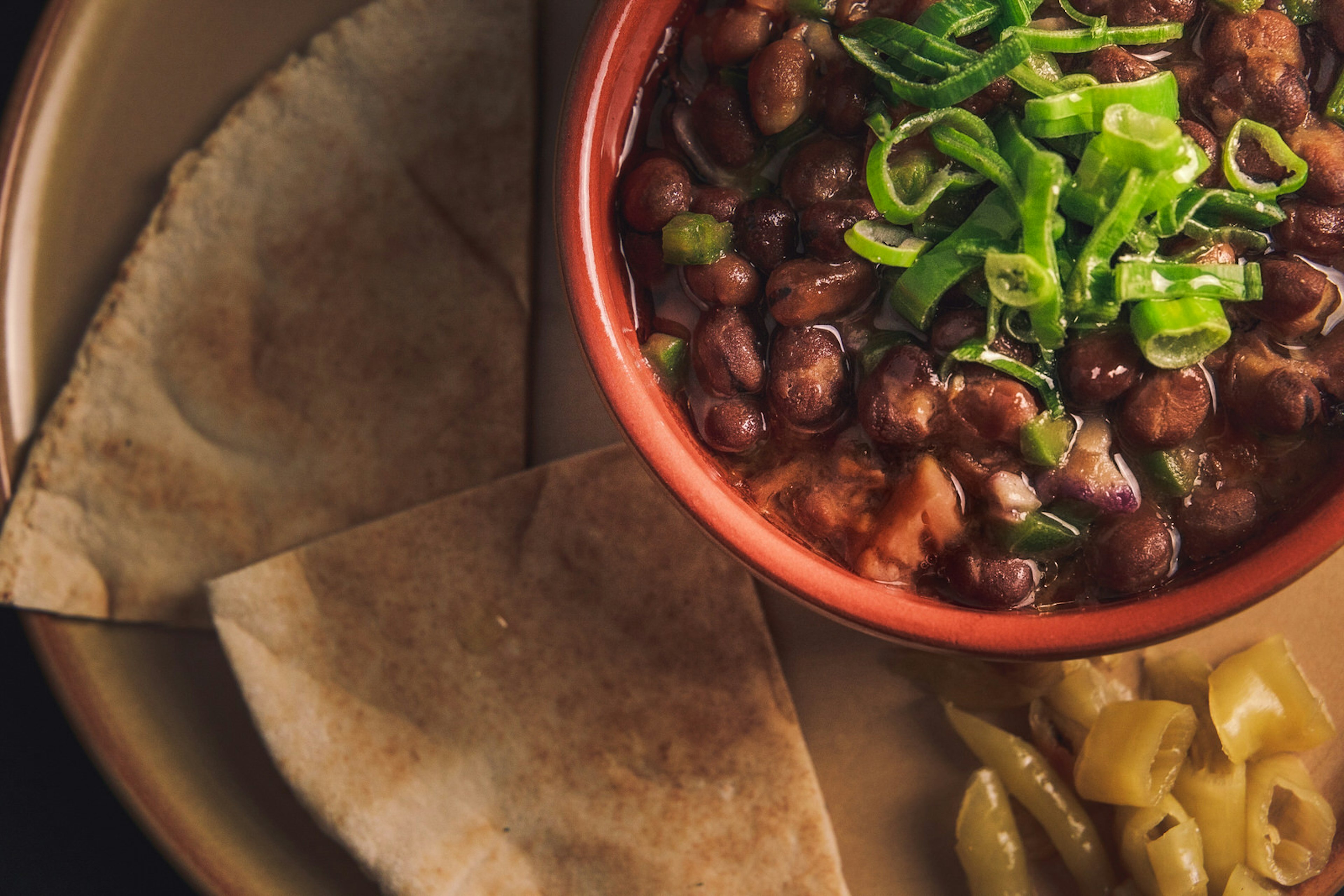 Fuul, fava beans with vegetables and pita bread, often eaten for breakfast in Egypt © Adamsgraphy / Shutterstock