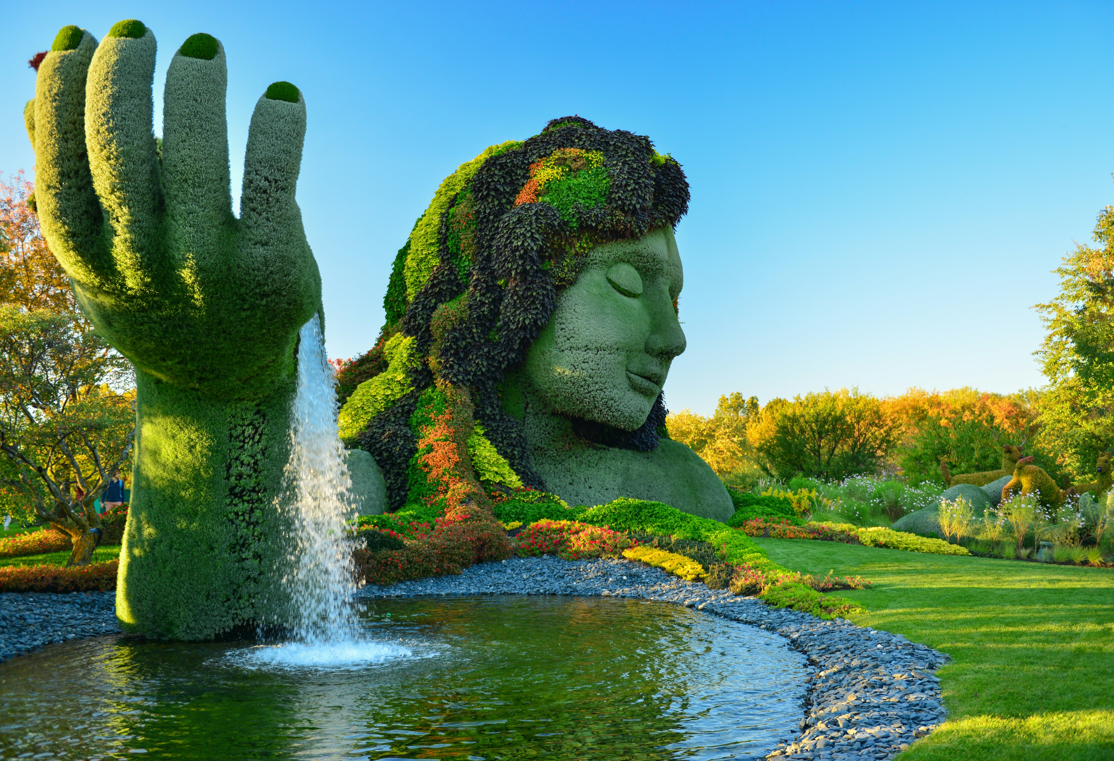 A bust of a woman covered in plants at the Montreal Botanical Garden.