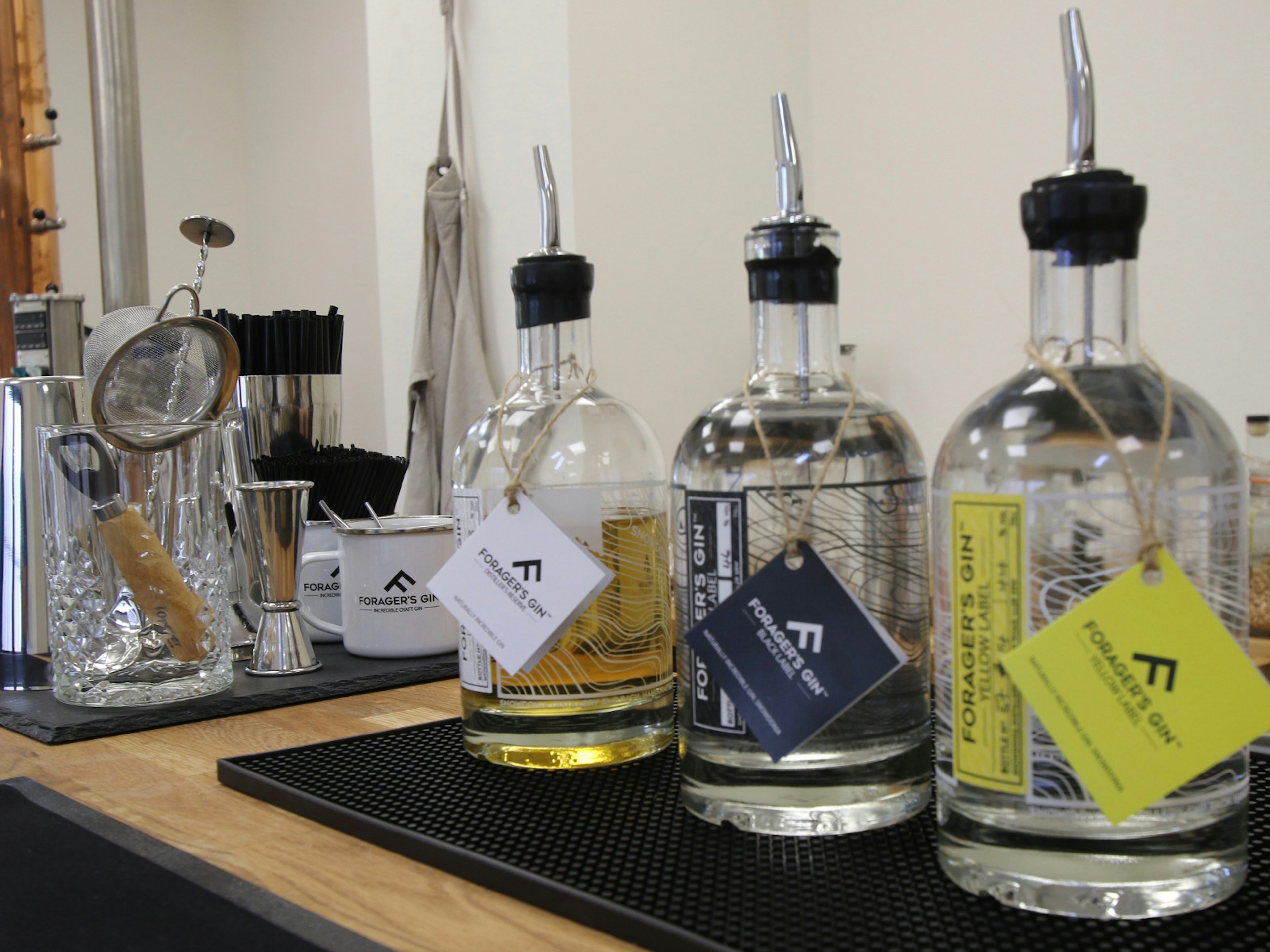 Three bottles of gin on a work surface at the Snowdonia Distillery