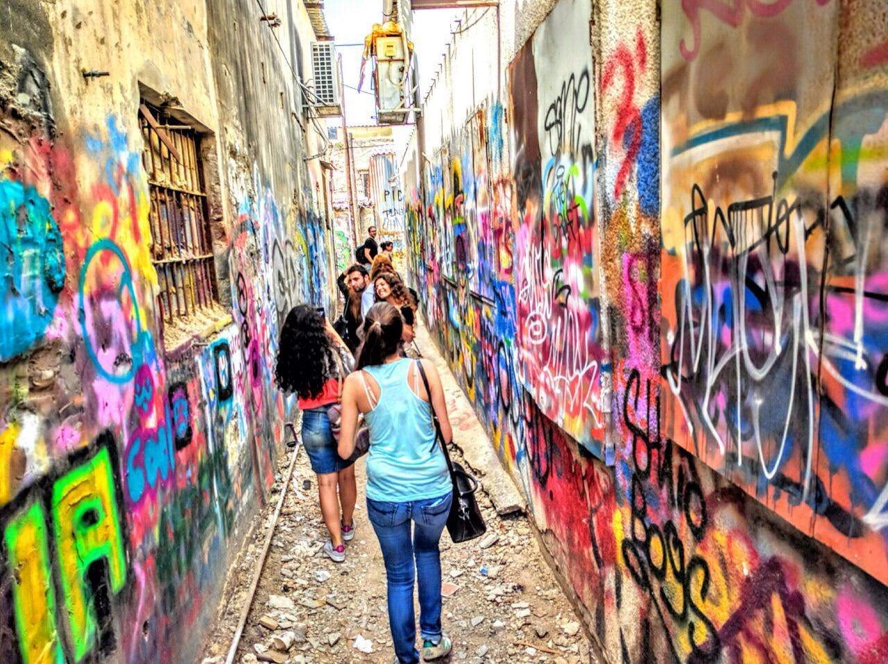 Graffiti tour in Tel Aviv alley. Image by Grafitiyul