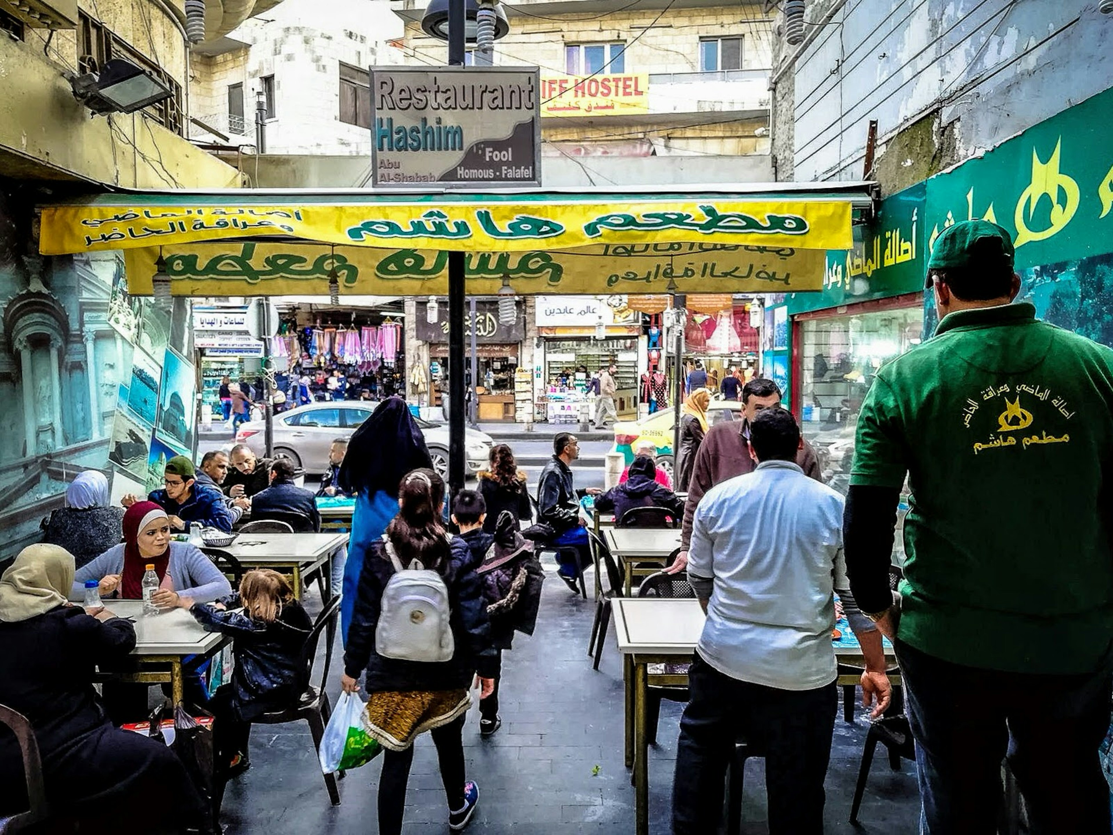 Eating falafel at Hashem Restaurant, Amman, Jordan. Image by Sunny Fitzgerald / Lonely Planet