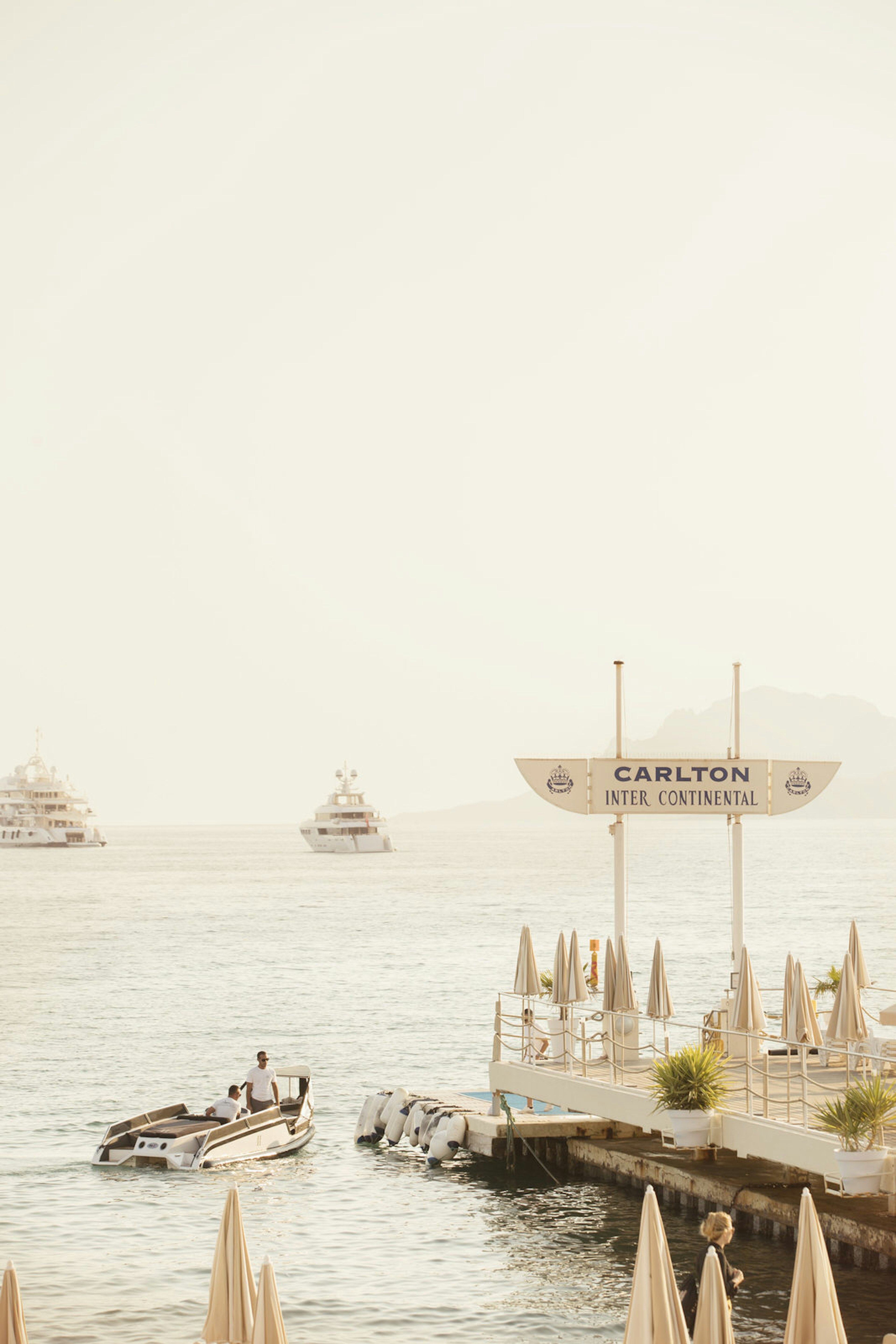 A smaller boat leaves the pier on the waters edge in the Carlton Beach Club © Philip Lee Harvey/iBestTravel