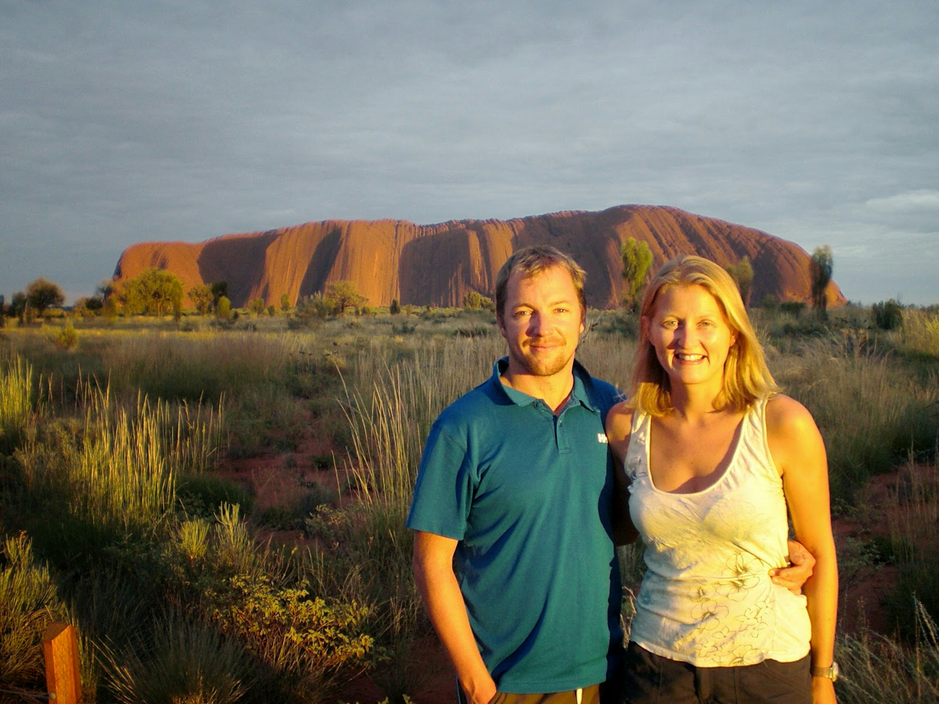 James and his partner pose in front of Uluru, Australia.